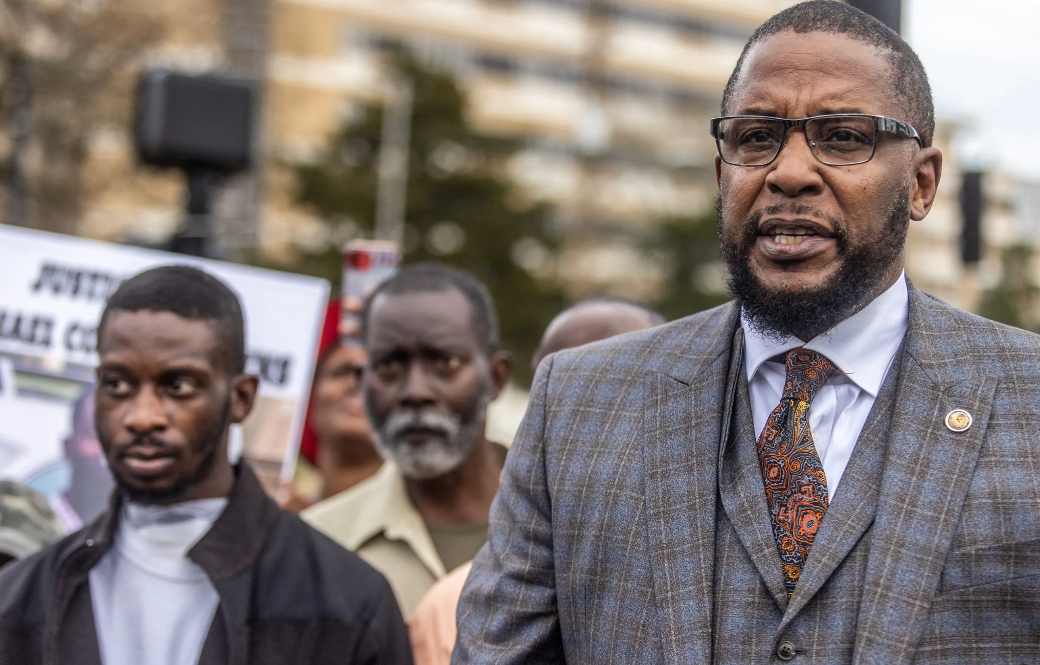 One of the victims, Michael Jenkins, with lawyer Malik Shabazz