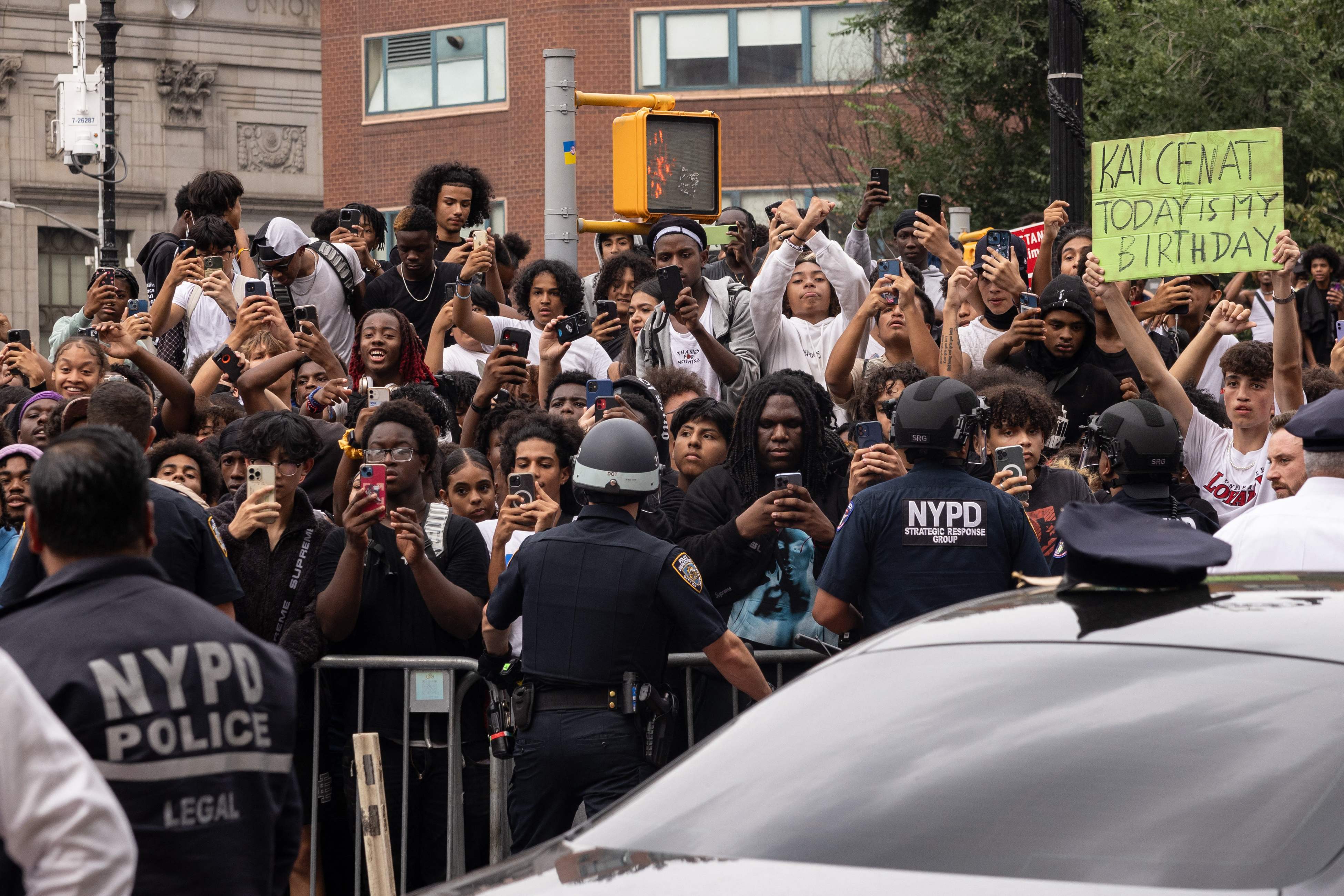 Police officers push back the crowd during the riot