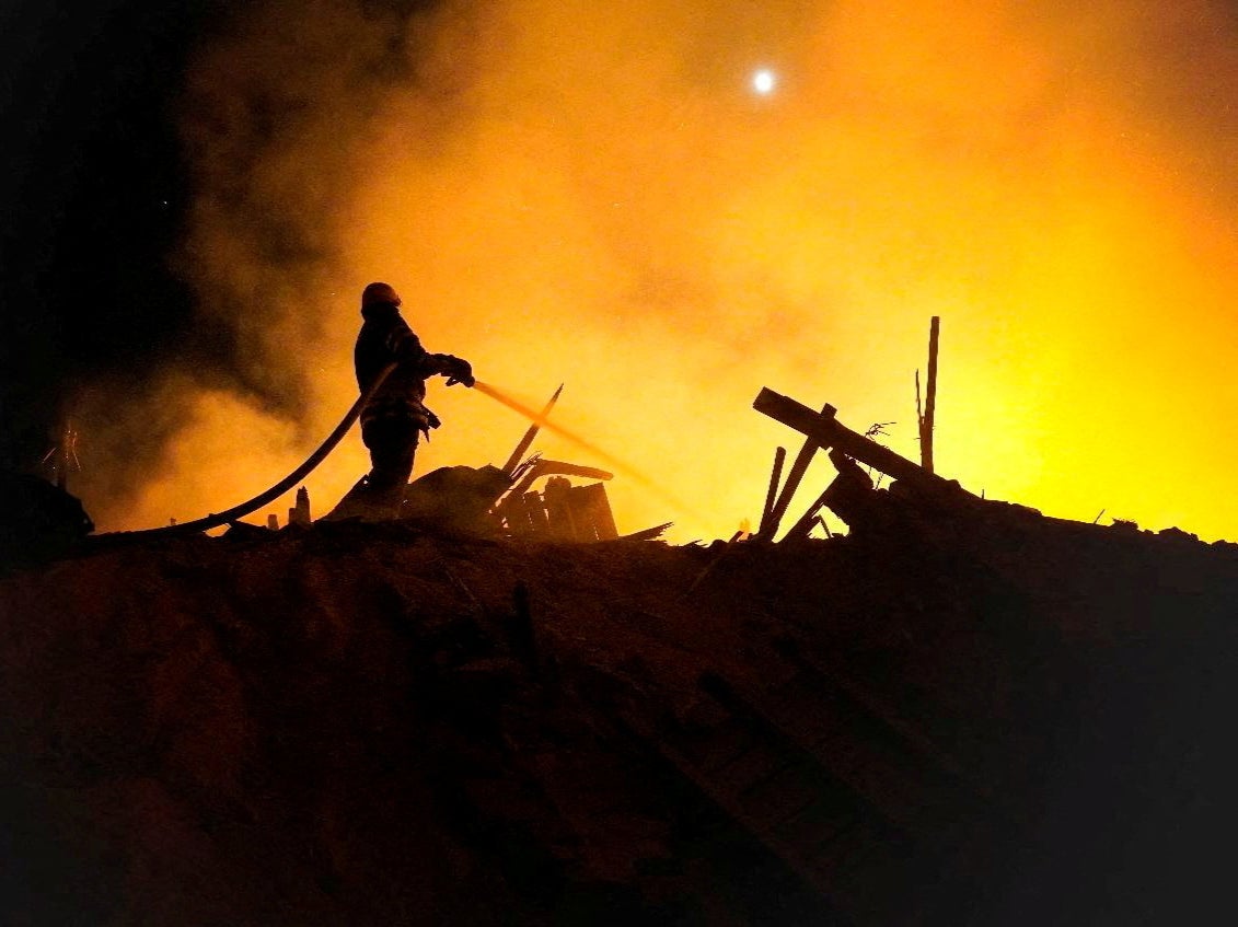 A firefighter extinguishes a fire in the aftermath of an attack, amid Russia's attack on Ukraine, in the Starokostiantyniv, Khmelnytskyi Region