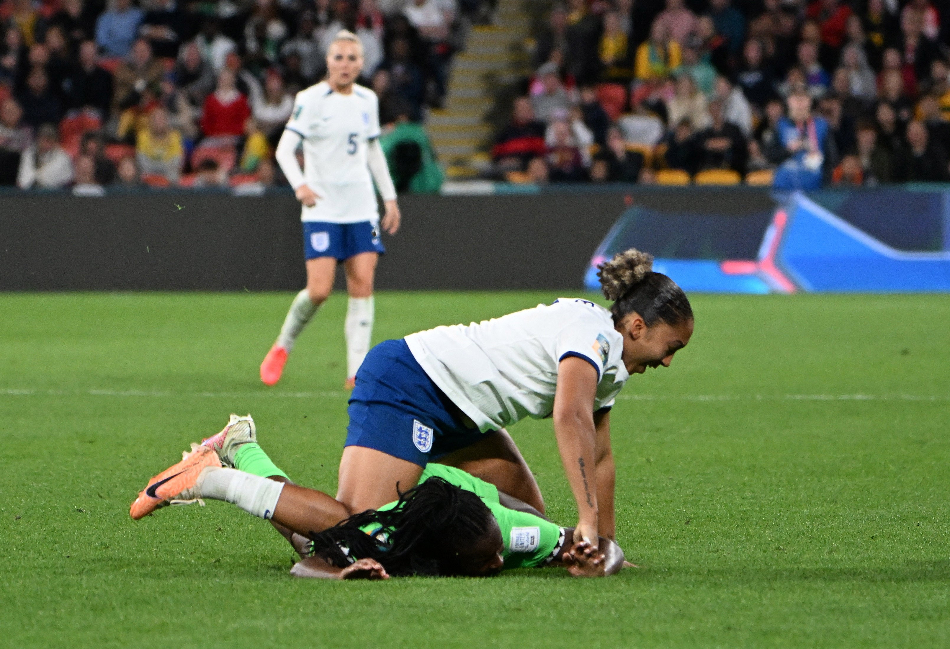 Lauren James of England stamps Michelle Alozie of Nigeria