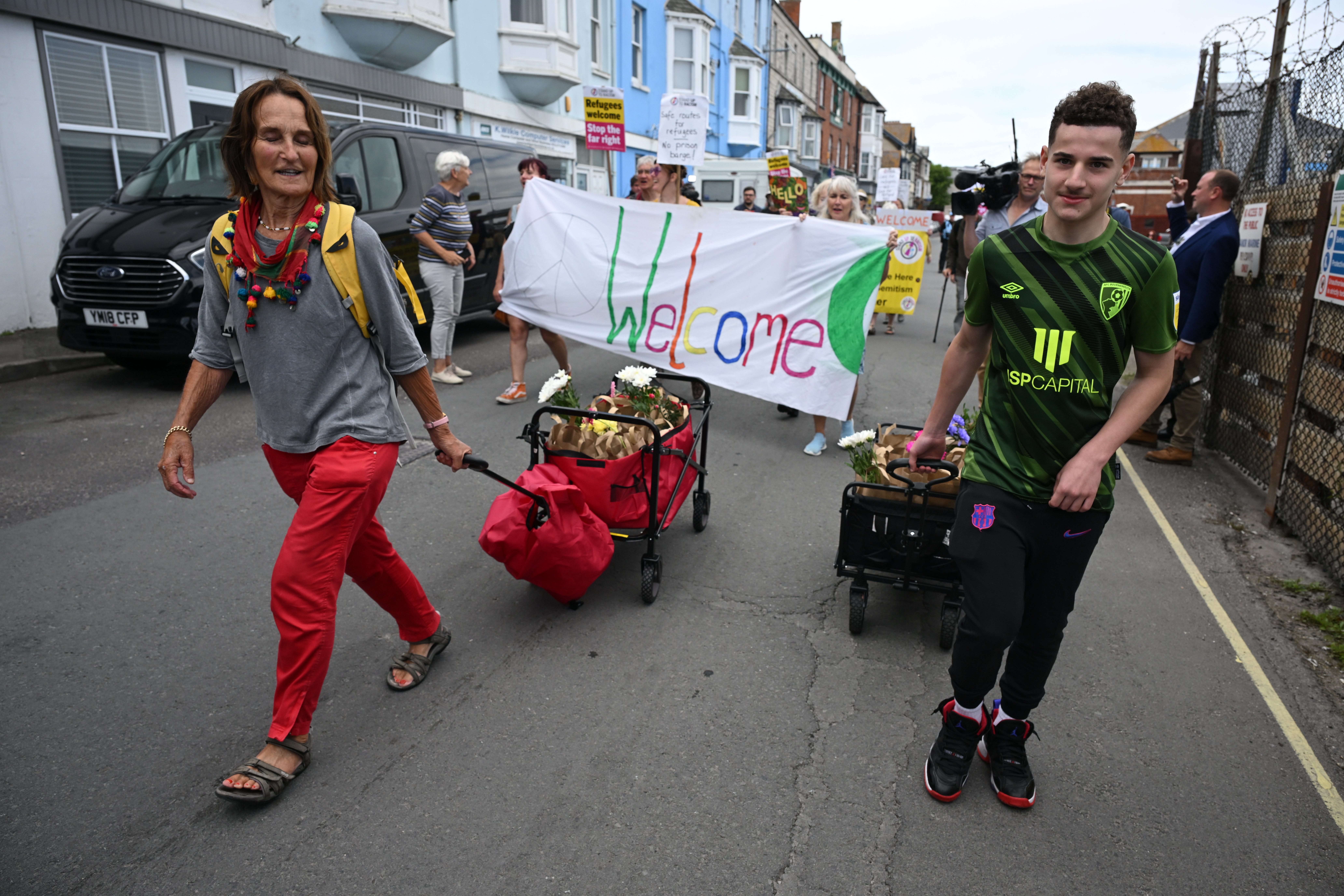 Protesters delivered ‘welcome packs’ as the first 15 migrants arrived at the barge on Monday – just four days before being evacuated