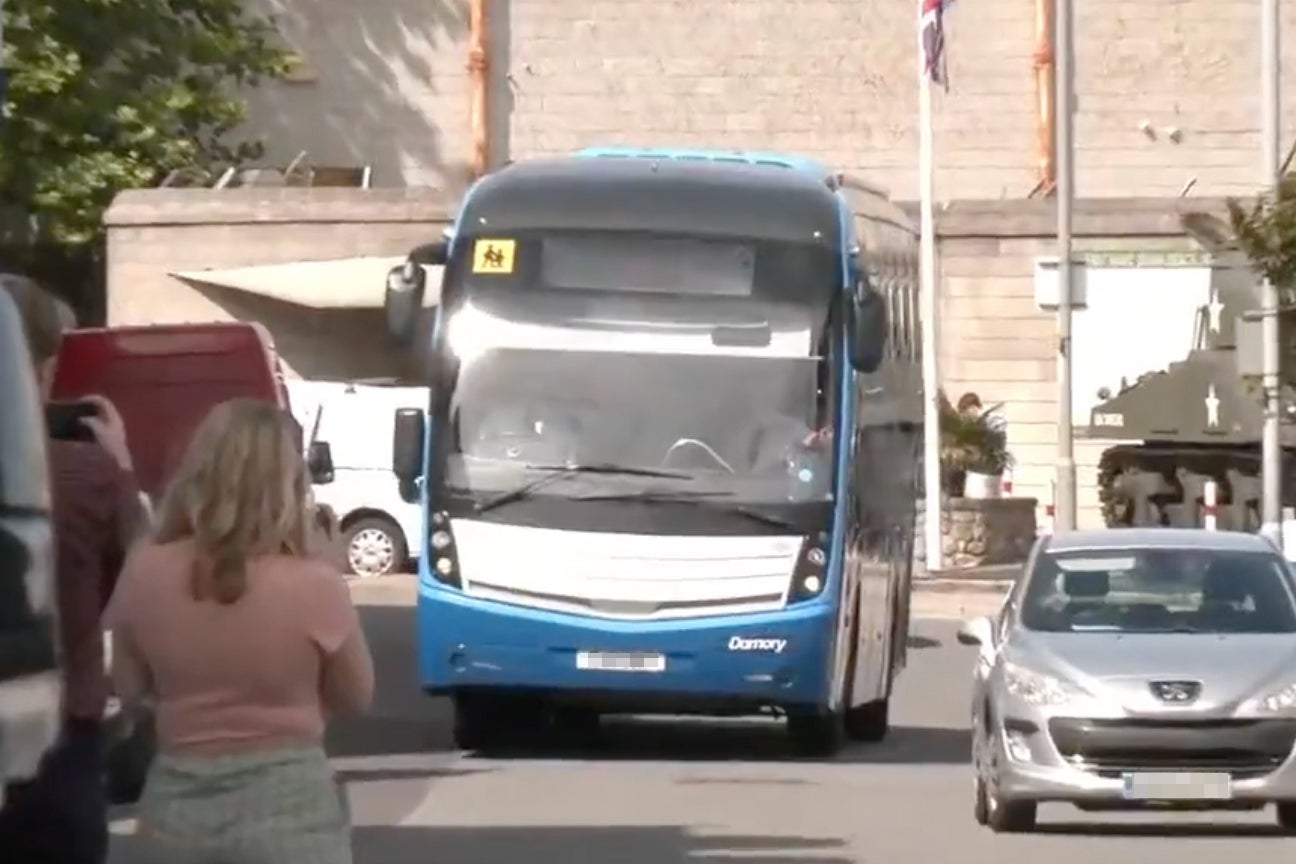 A coach carrying asylum seekers arriving at Portland Port on Monday morning