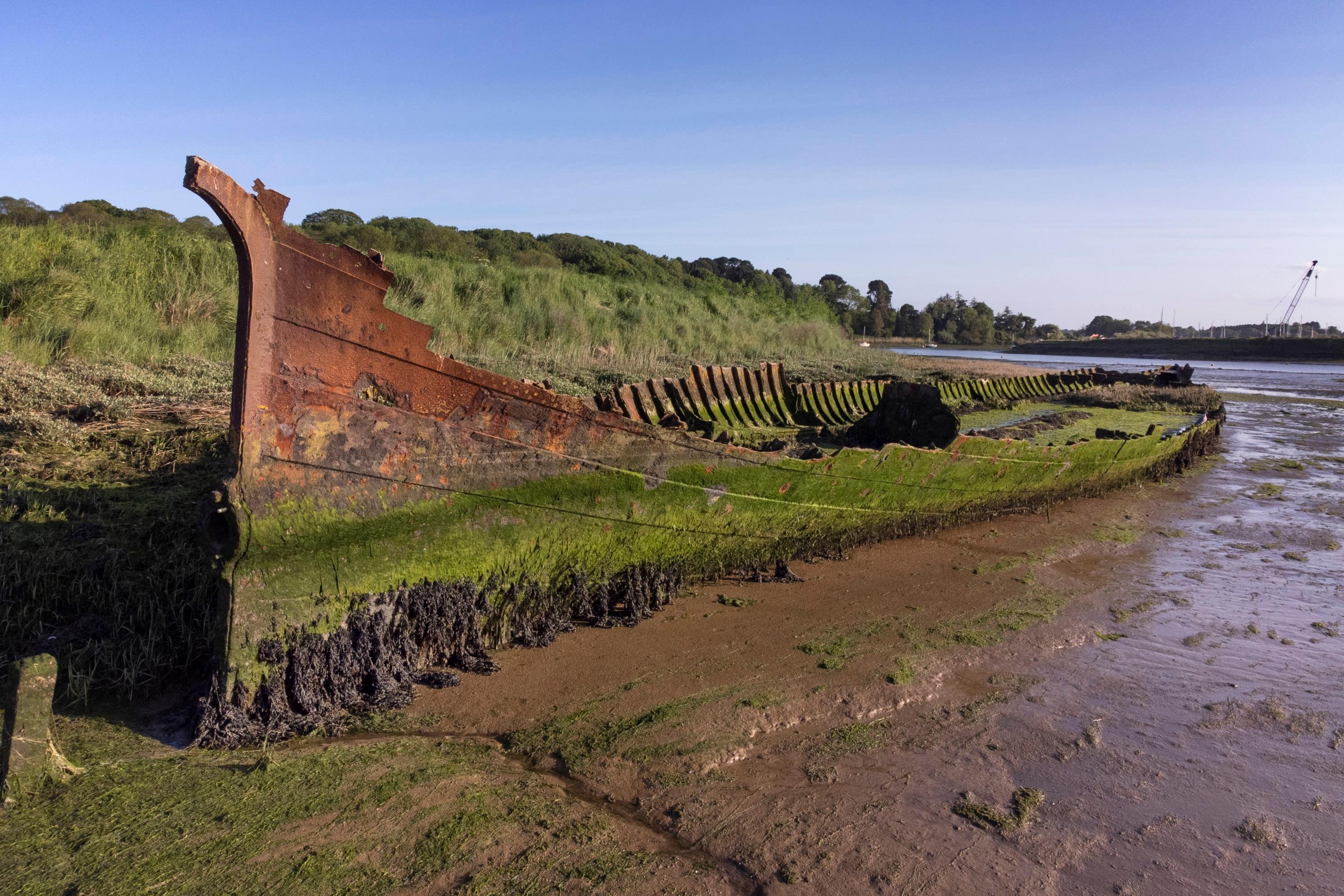 The hulk of Victorian ship the Lady Alice Kenlis, in the River Deben in Suffolk, has been granted protected status (Historic England Archive/PA)