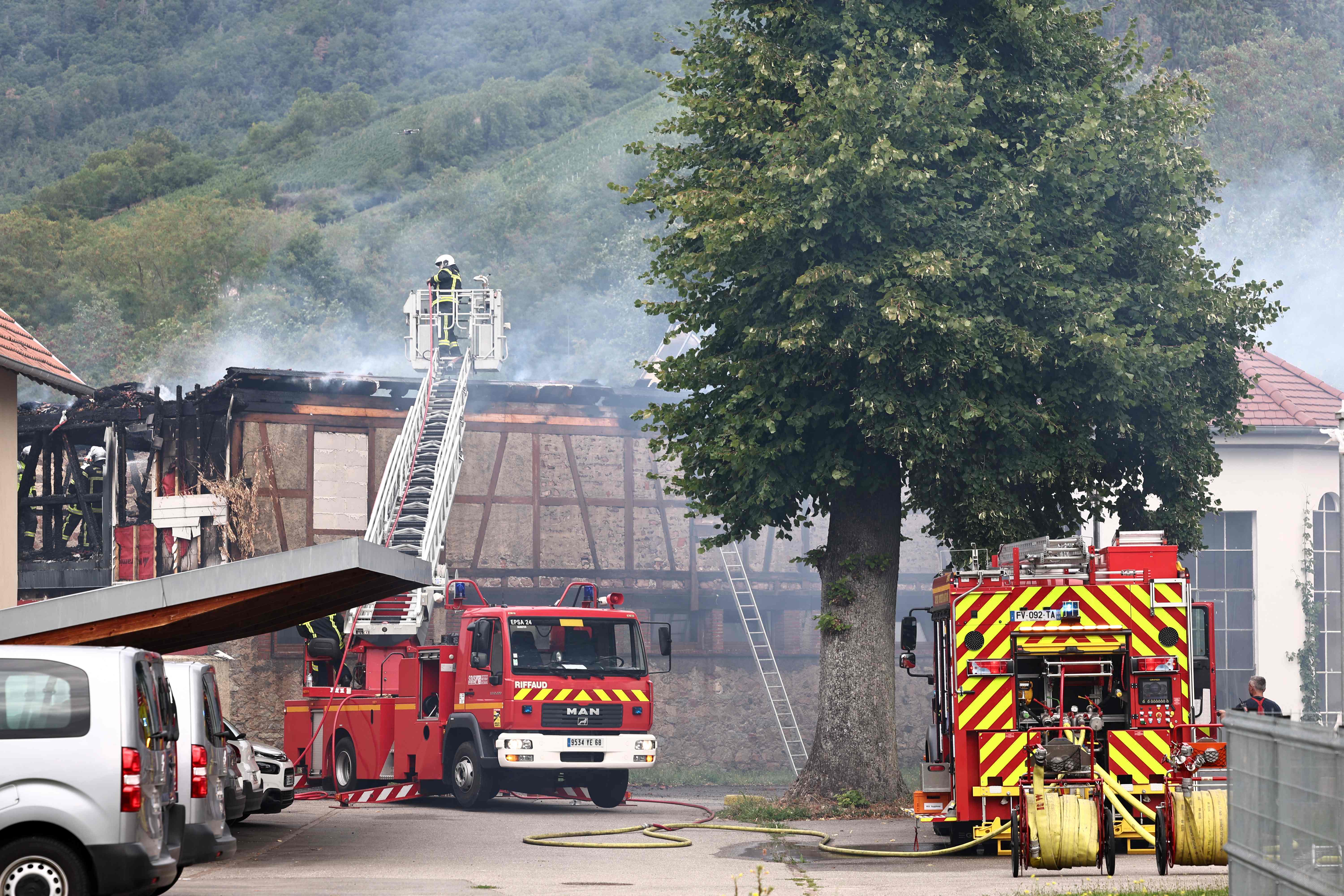 Firefighters tackling a fire that erupted at a home for disabled people in Wintzenheim near Colmar, eastern France