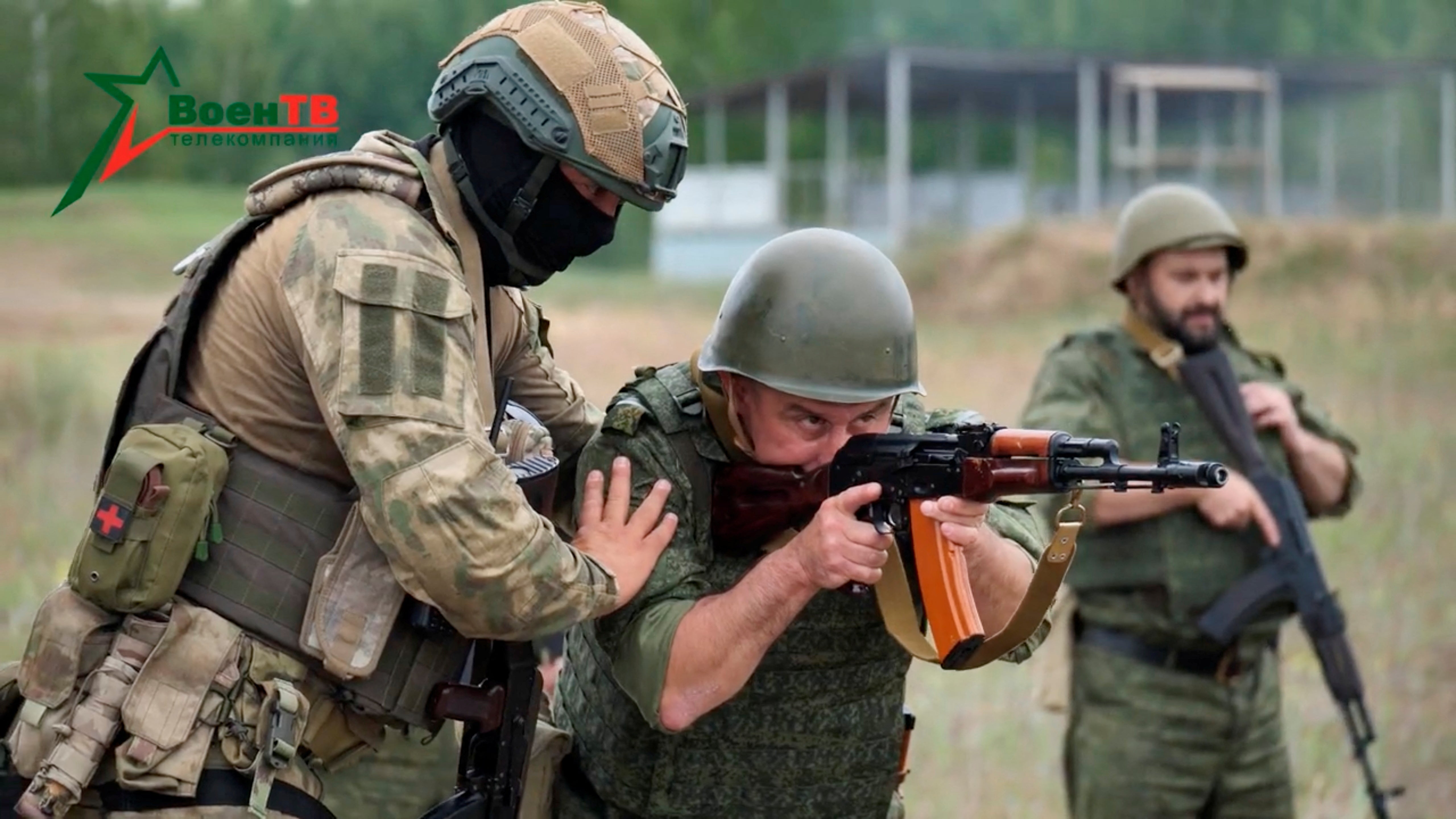 A fighter from the Wagner mercenary group trains Belarusian soldiers on a range near the town of Osipovichi