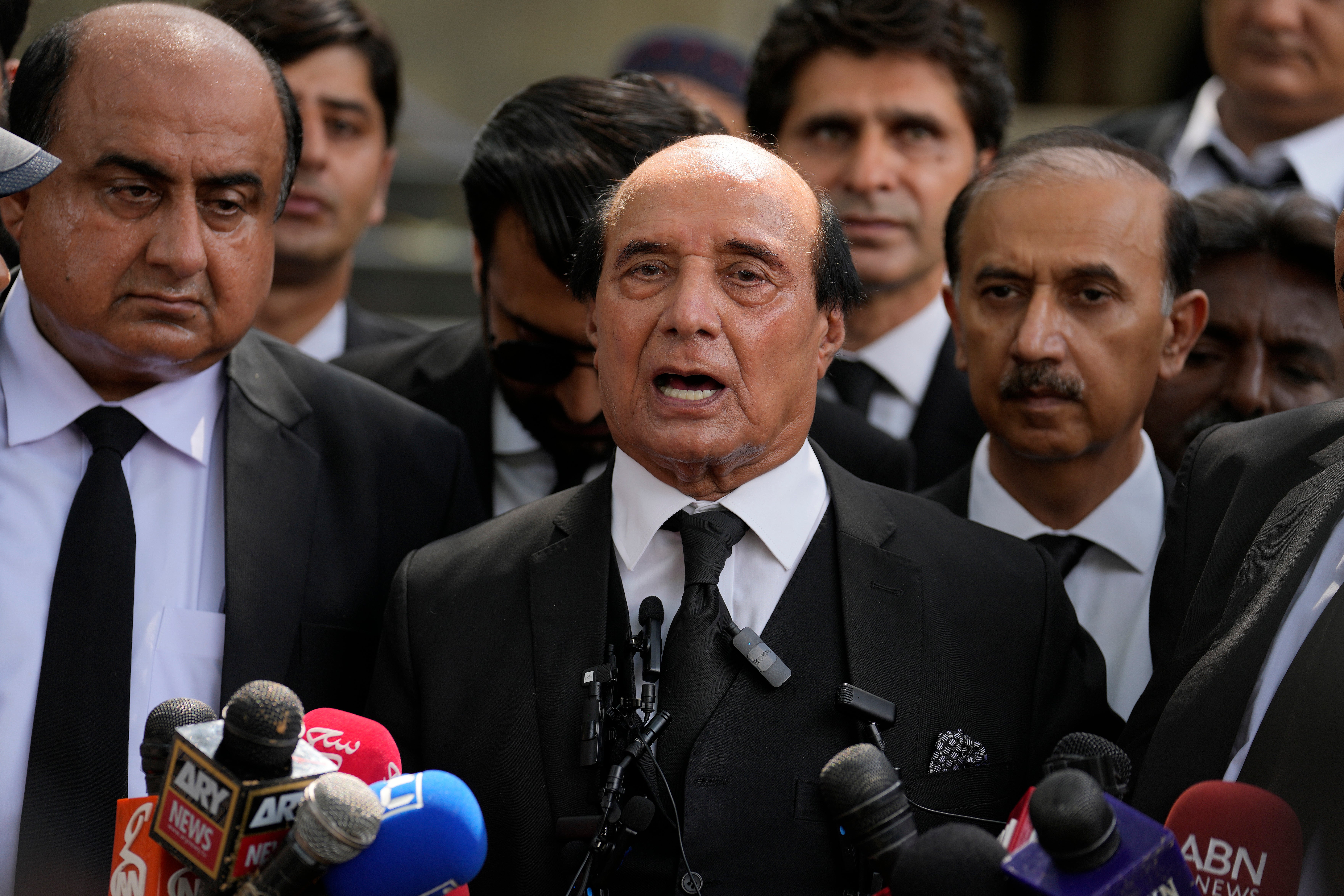 Latif Khosa, centre, a lawyer who is part of Imran Khan’s legal team, speaks with the media outside a court after Khan’s appeal hearing on Wednesday 9 August