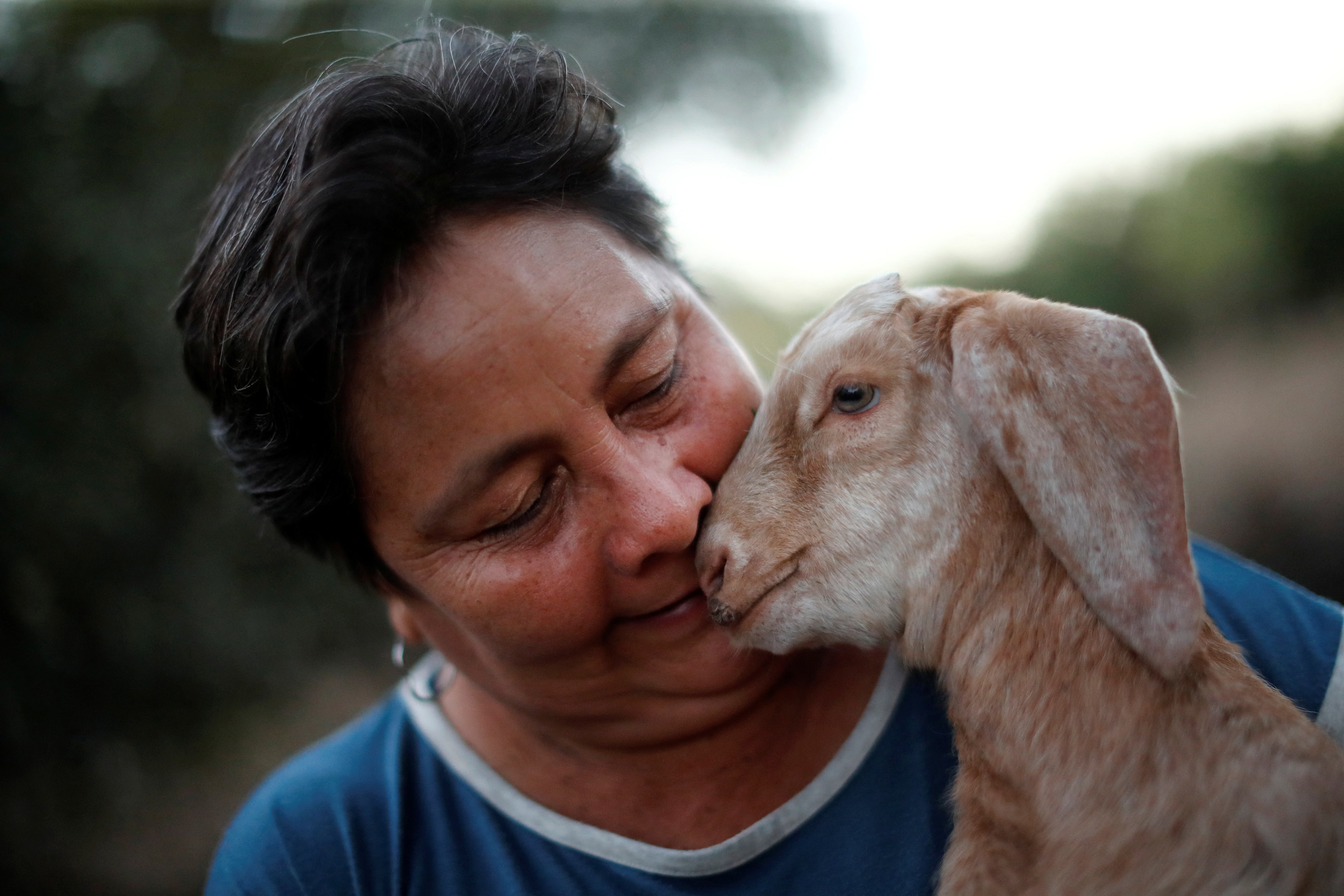 Teofila Palma holds a goat which she raises for meat, on her farm, in Pozo del Mortero, Formosa, Argentina