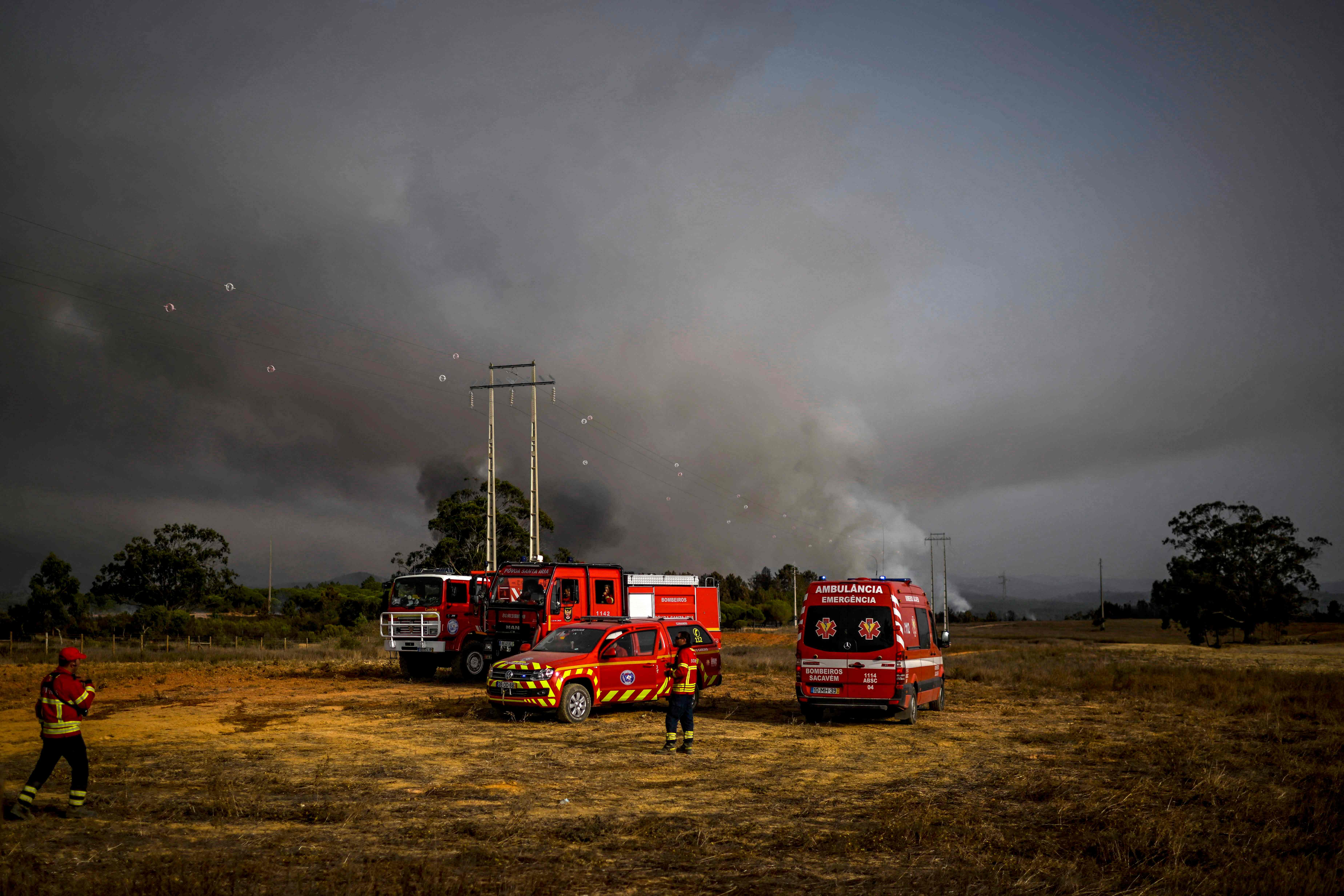 Firefighter watch the progression of a wildfire in Odeceixe, south of Portugal, 8 August