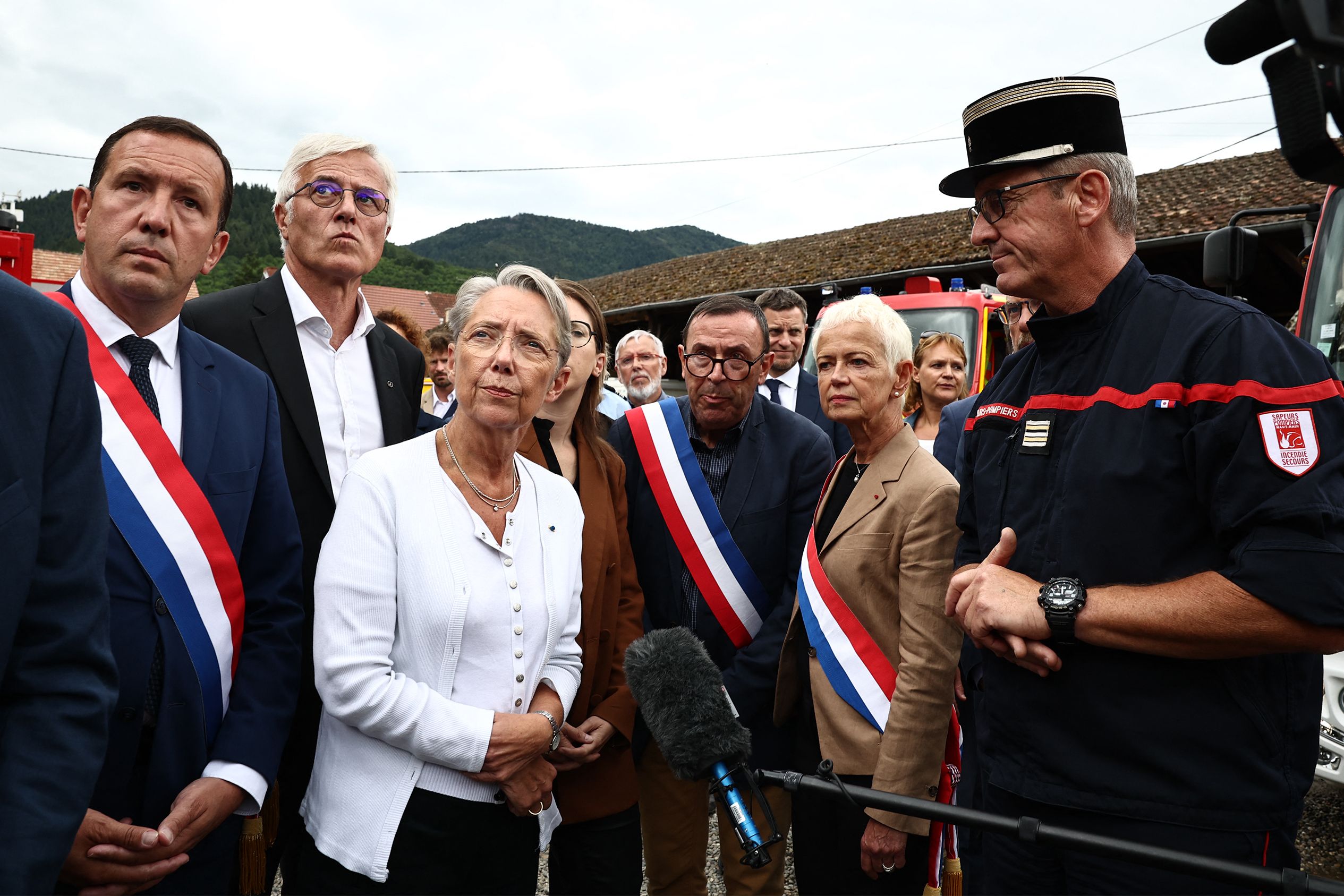 French Prime Minister Elisabeth Borne speaks with the head of the firefighters in charge of the rescue operations