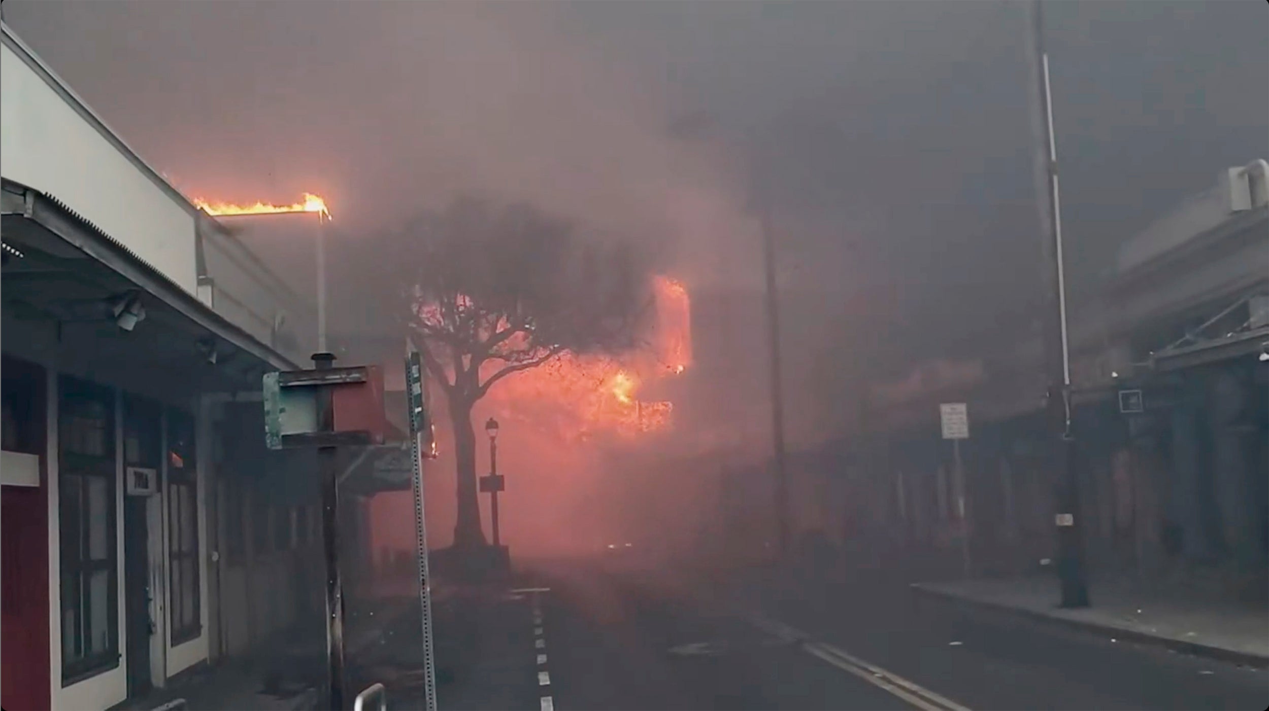 Smoke and flames fill the air from raging wildfires on Front Street in downtown Lahaina, Maui on 9 August