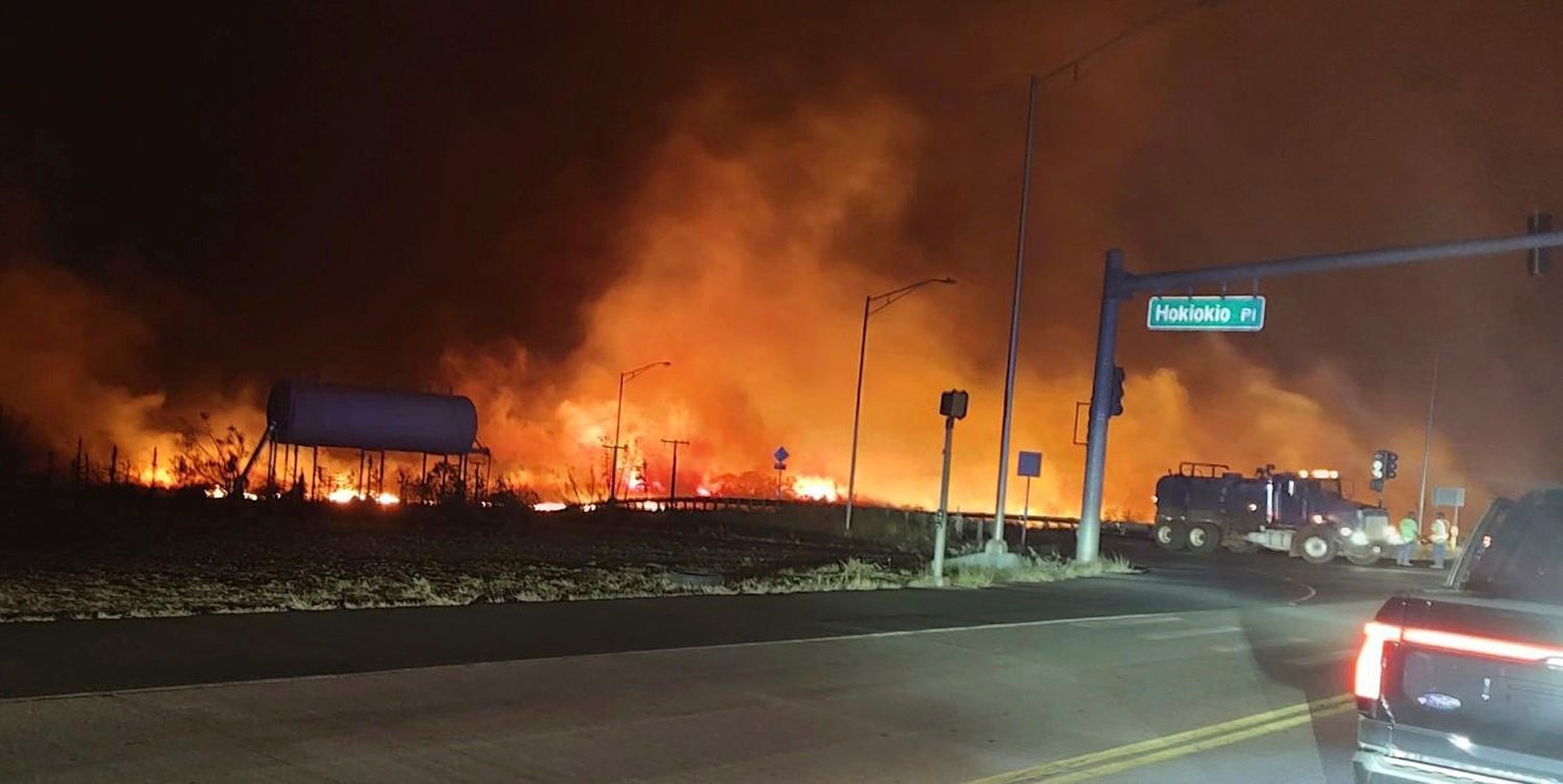 This photo provided by County of Maui shows fire and smoke filling the sky from wildfires on the intersection at Hokiokio Place and Lahaina Bypass in Maui, Hawaii on Tuesday, Aug. 8, 2023