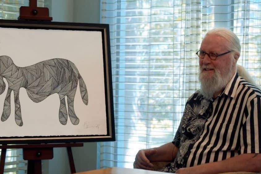 Sir Billy Connolly sits next to his newly unveiled piece, Drunken Donkey (Castle Fine Art/PA)