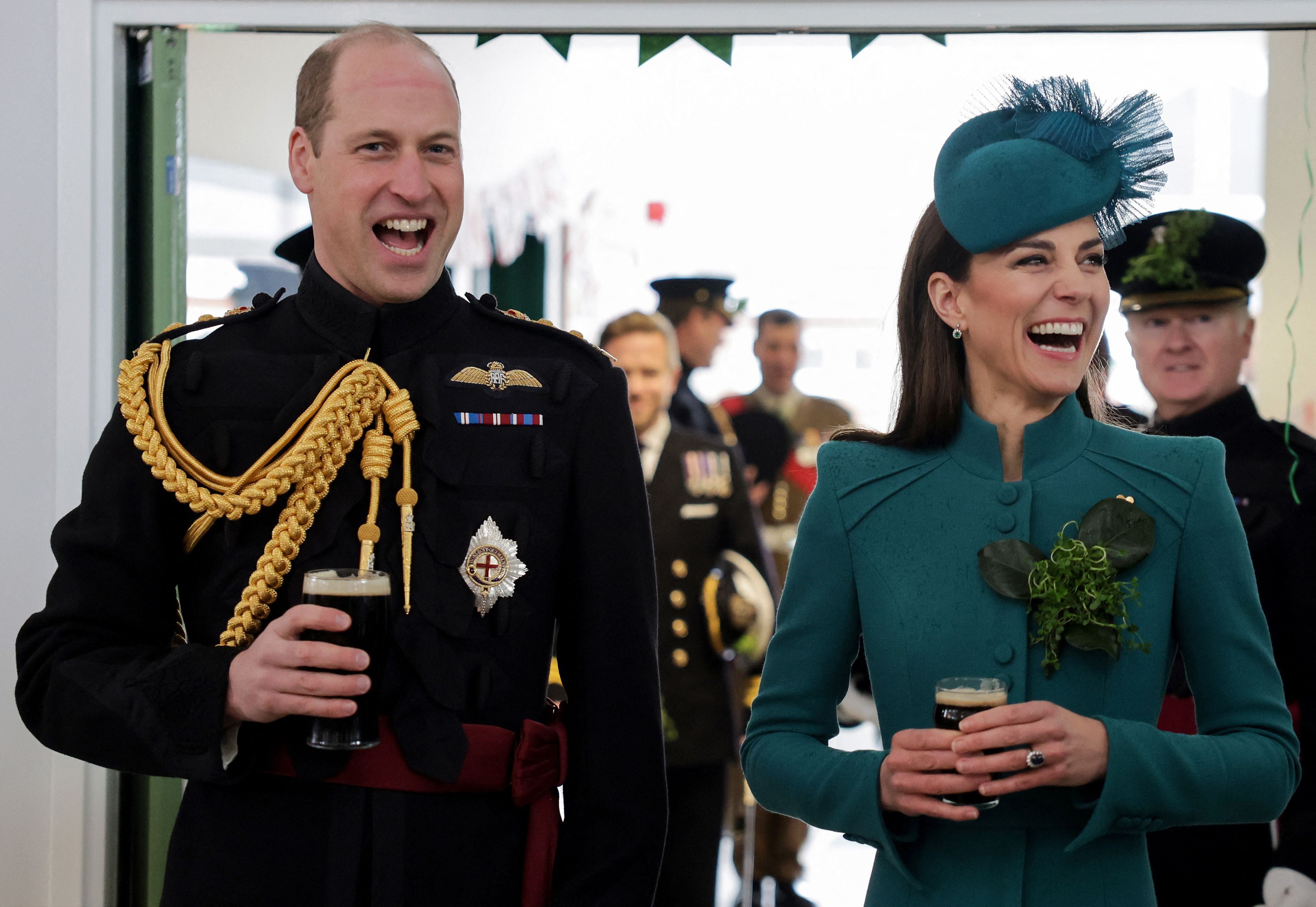 Prince William, Prince of Wales (L) and Catherine, Princess of Wales enjoy a drink of Guinness with members of the 1st Battalion Irish Guards, following their St Patrick's Day Parade at Mons Barracks in Aldershot, south west of London, on March 17, 2023