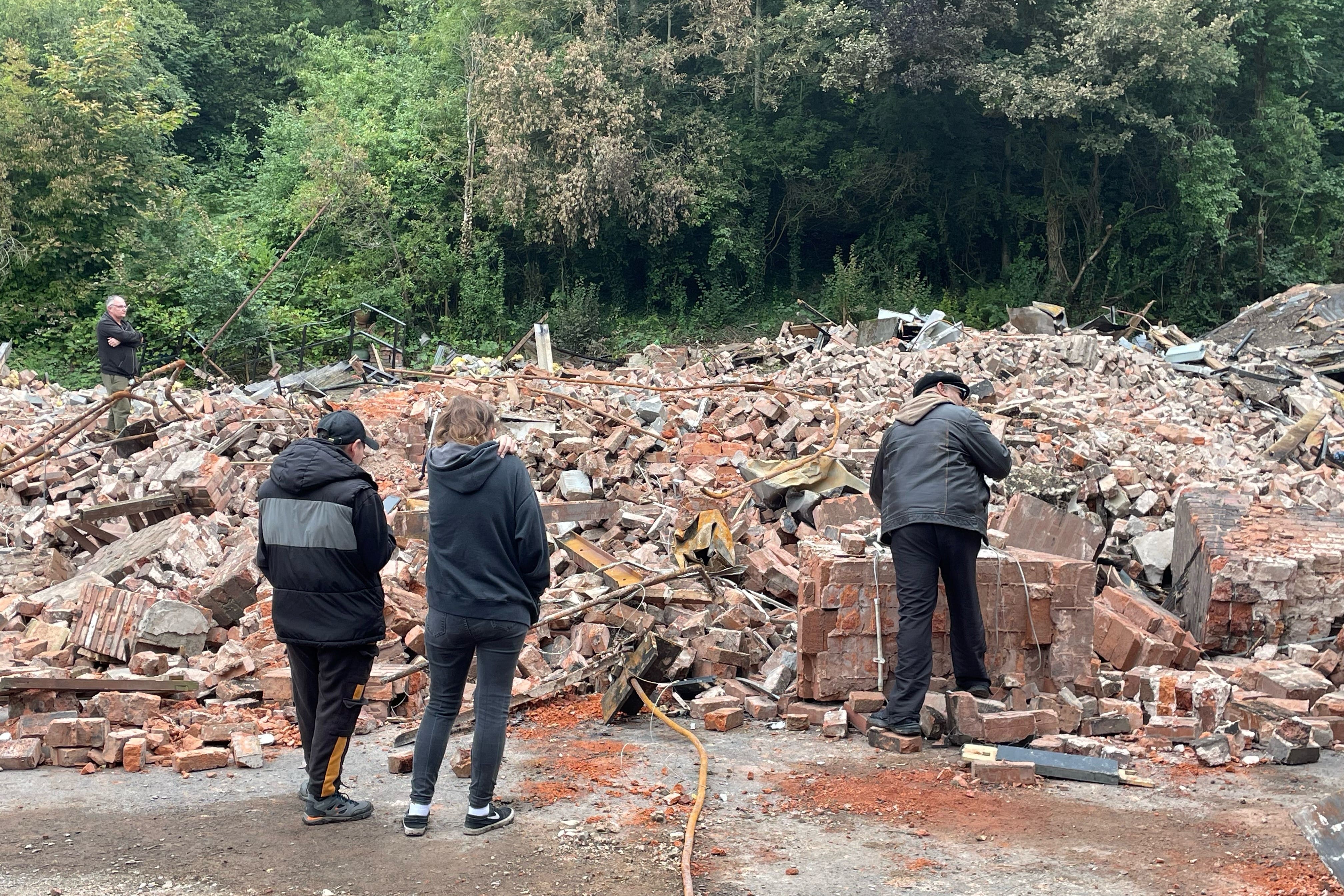 People inspect the rubble remains of The Crooked House pub in Himley, near Dudley, West Midlands (Matthew Cooper/PA)