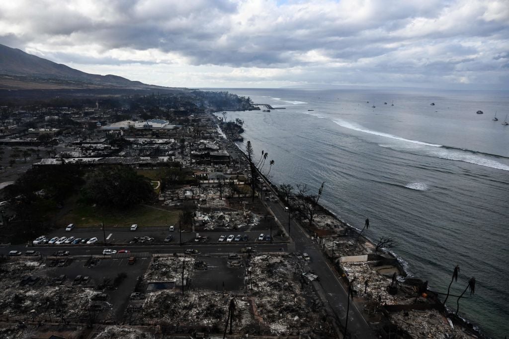 An aerial image taken on August 10, 2023 shows destroyed homes and buildings burned to the ground in Lahaina along the Pacific Ocean in the aftermath of wildfires in western Maui, Hawaii