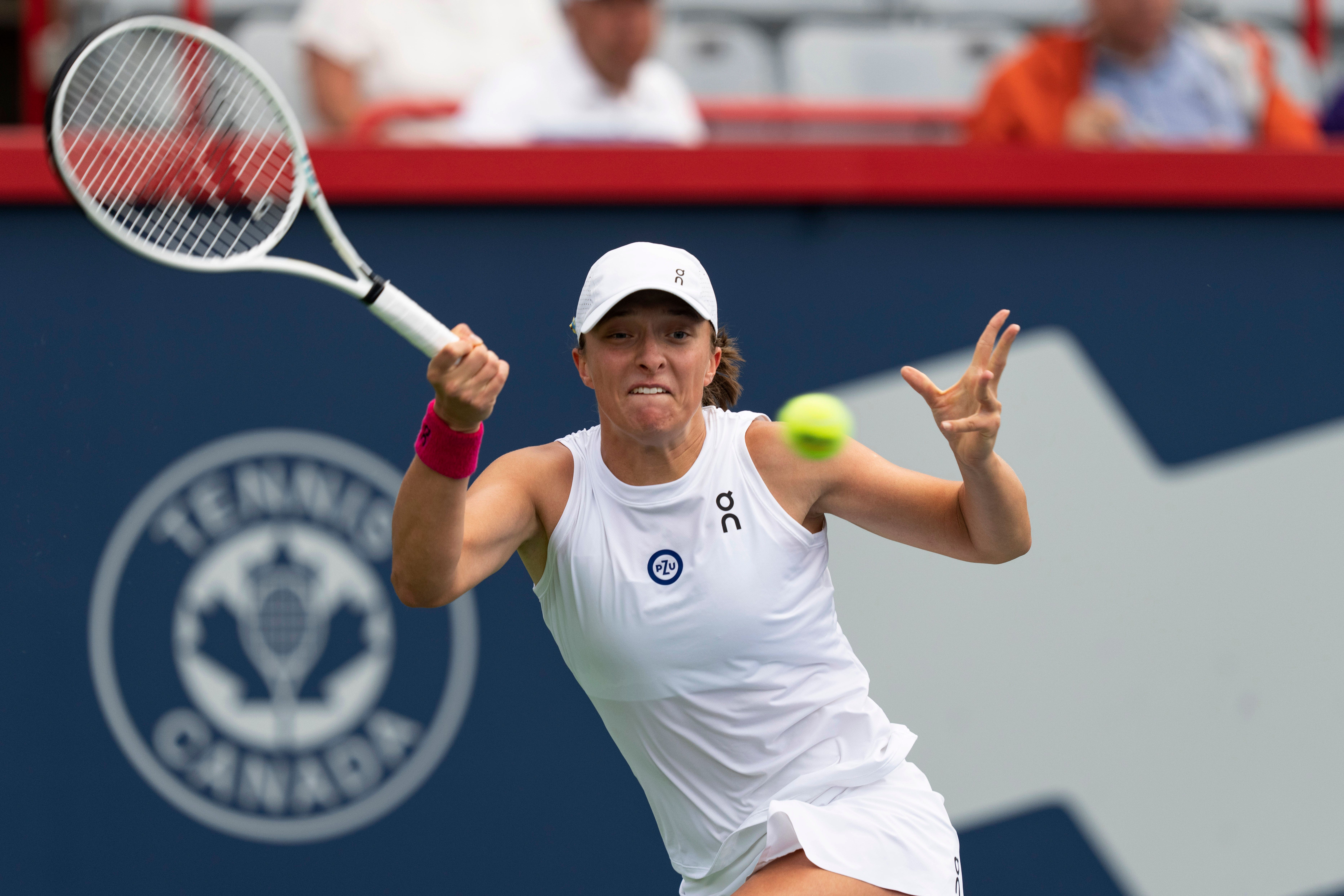 Iga Swiatek hits a forehand to Danielle Collins during the National Bank Open tournament in Montreal (Christinne Muschi/The Canadian Press via AP)