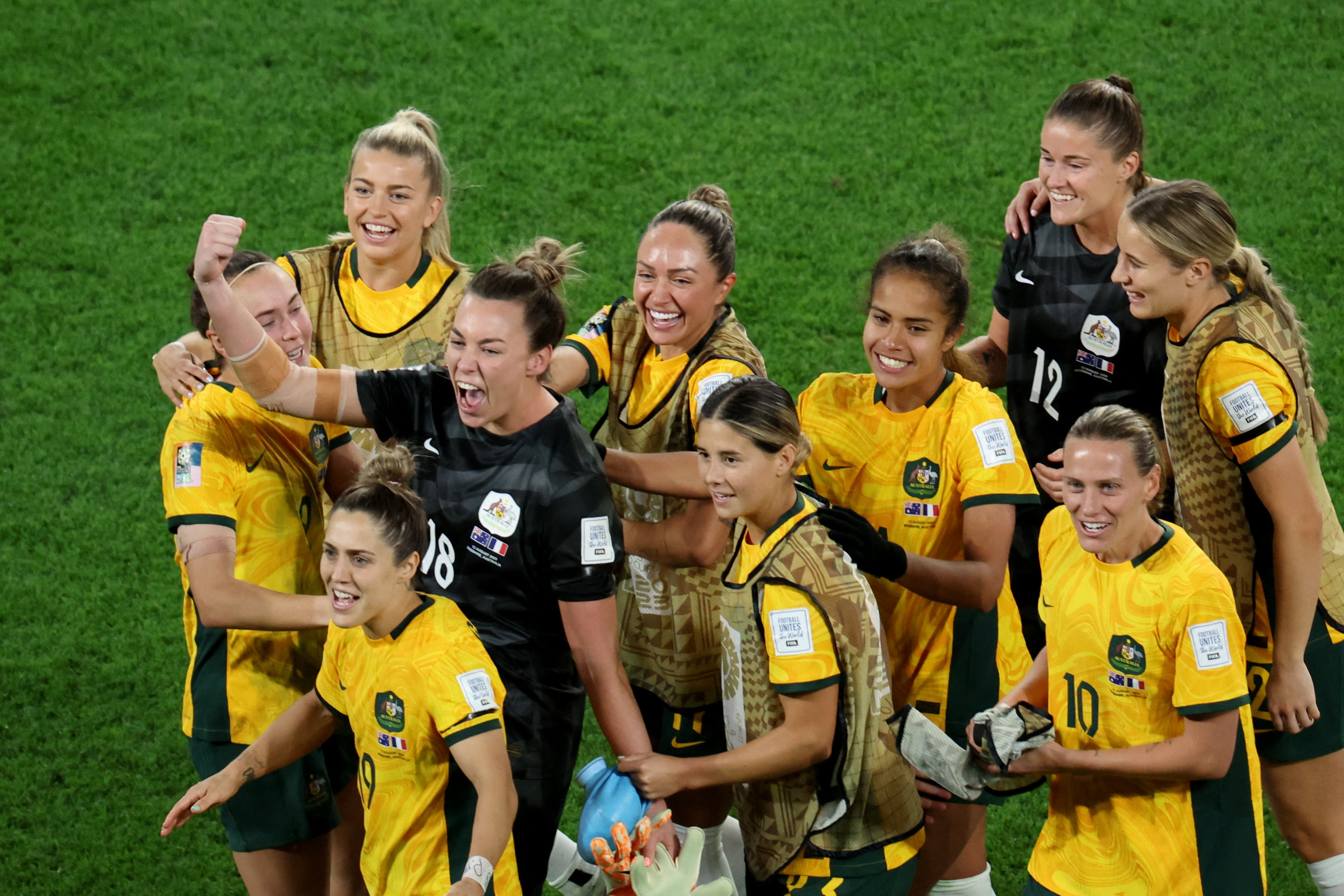 Australia’s Mackenzie Arnold celebrates with teammates