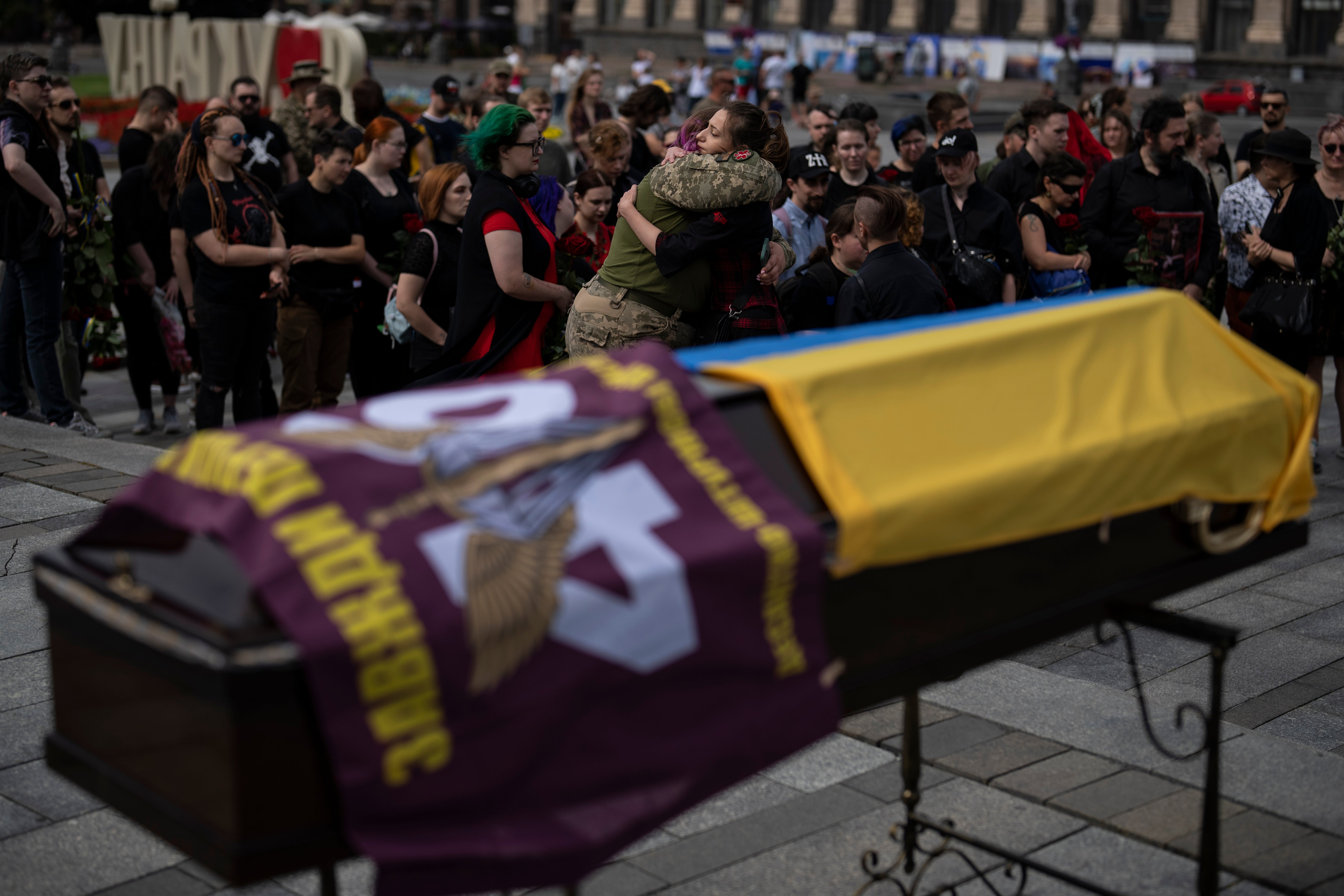 Friends hug each other at Daira Filipova’s funeral in Kyiv