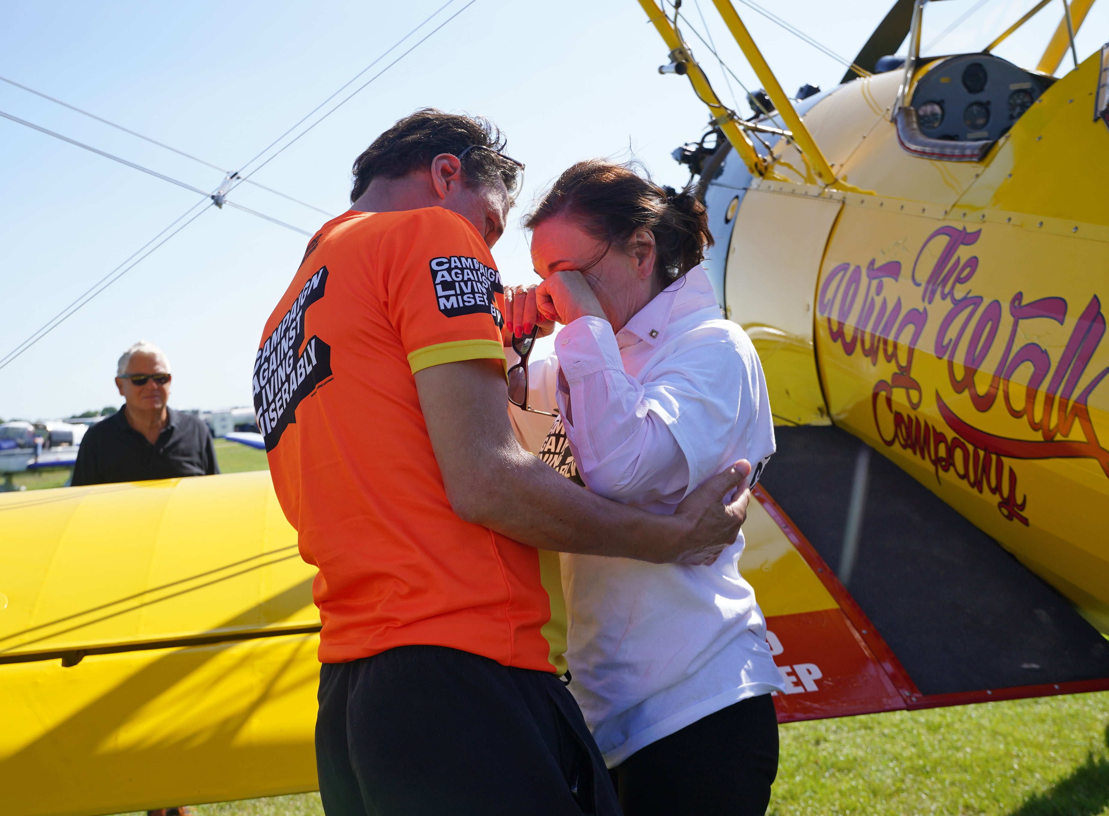 Shirley Ballas is embraced by Daniel Taylor after completing her wing walk for the Campaign Against Living Miserably (CALM)