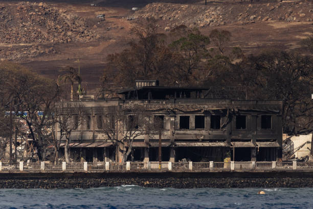 Destroyed buildings and homes are seen from a boat in the aftermath of a wildfire in Lahaina, western Maui, Hawaii on 12 August 2023