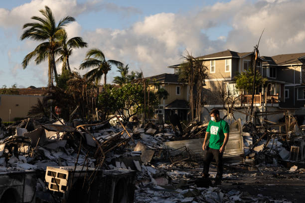 A Mercy Worldwide volunteer makes damage assessment of charred apartment complex in the aftermath of a wildfire in Lahaina, western Maui, Hawaii on 12 August 2023