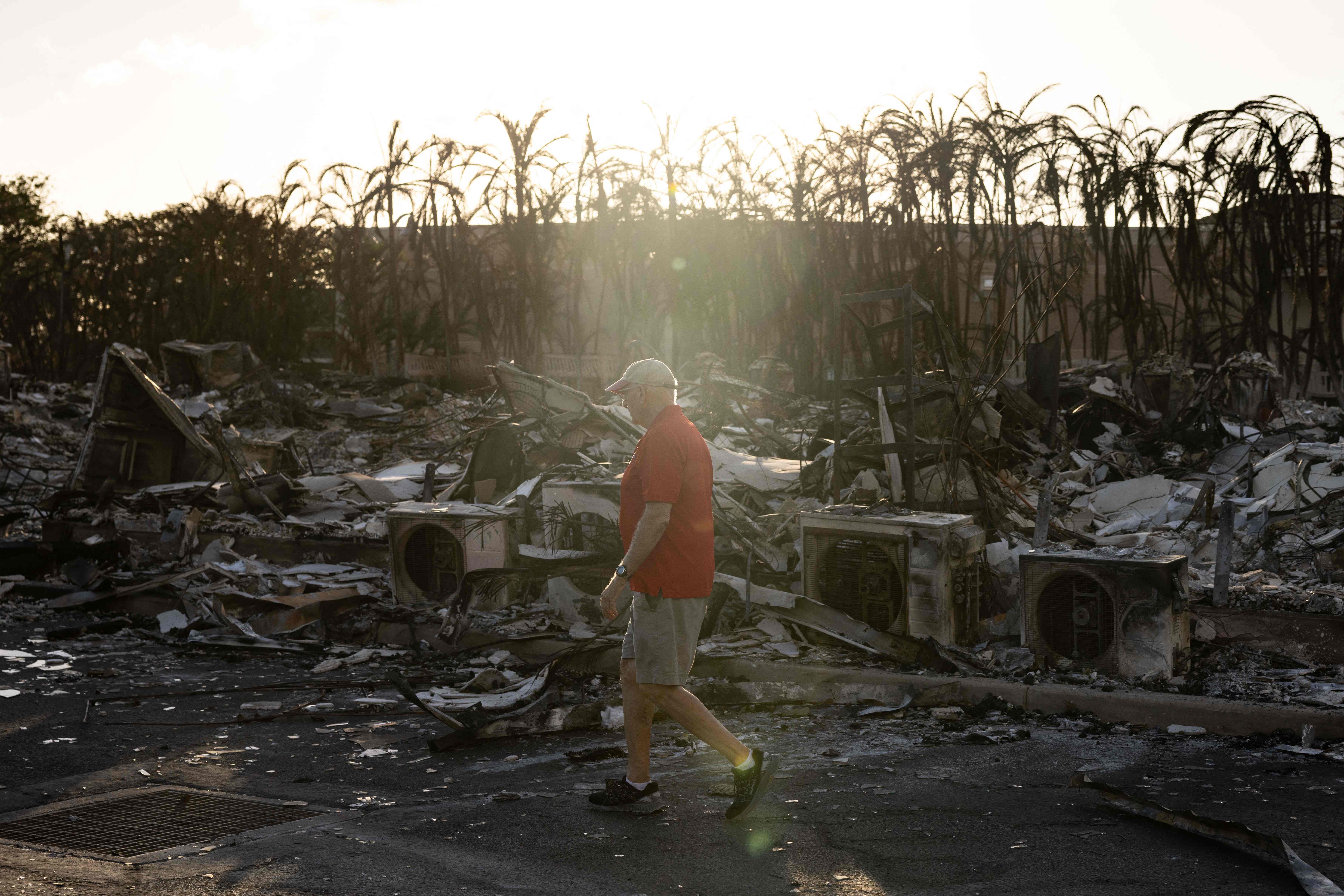 A resident looks around a charred apartment complex in the aftermath of a wildfire in Lahaina, western Maui, Hawaii