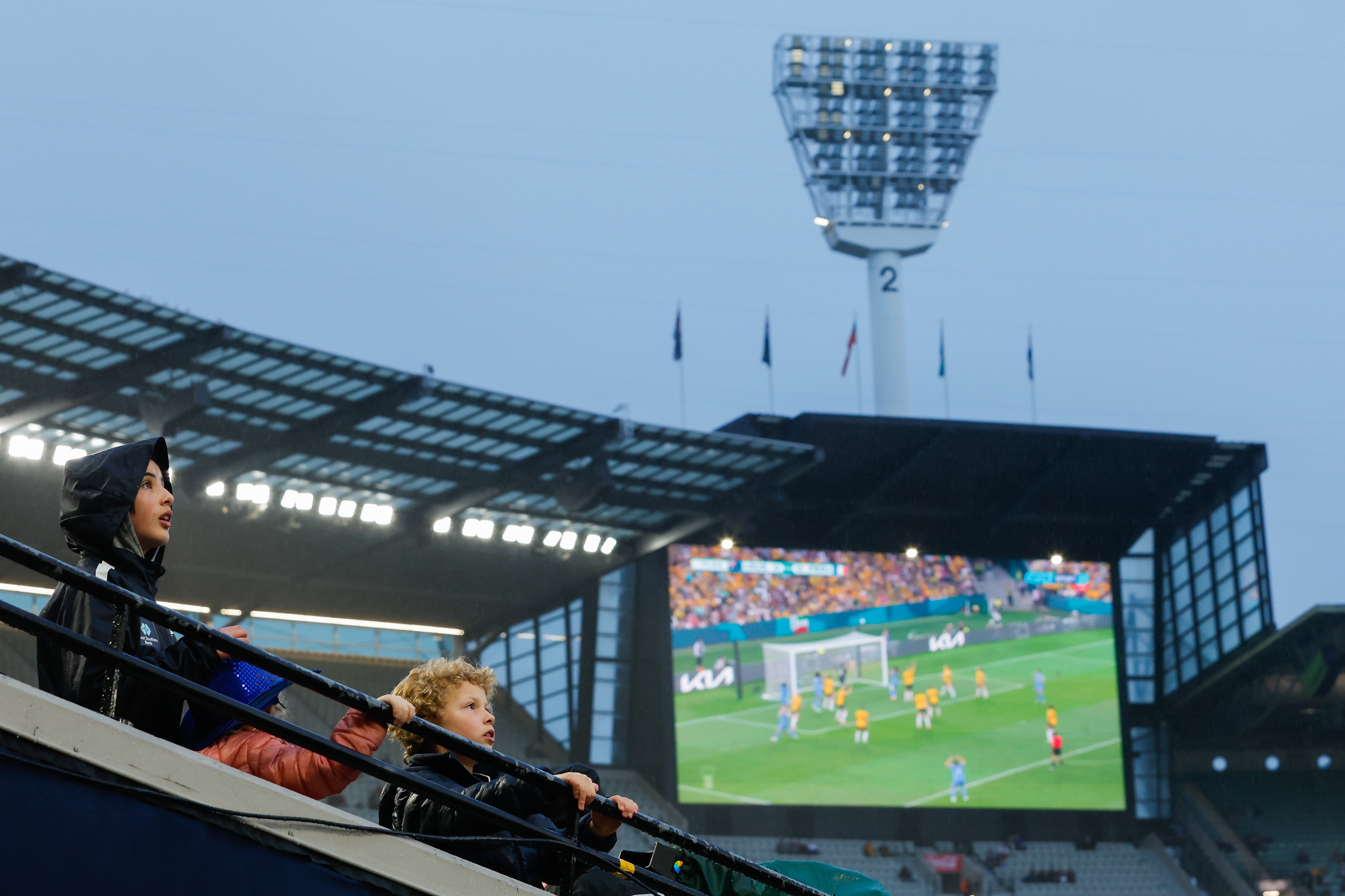 Young fans at the MCG watch the Matildas before Melbourne vs Carlton