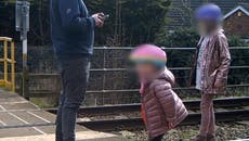 ‘There’s a train coming’: Toddler dances on train tracks as oblivious father plays on phone