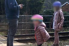 ‘There’s a train coming’: Toddler dances on train tracks as oblivious father plays on phone