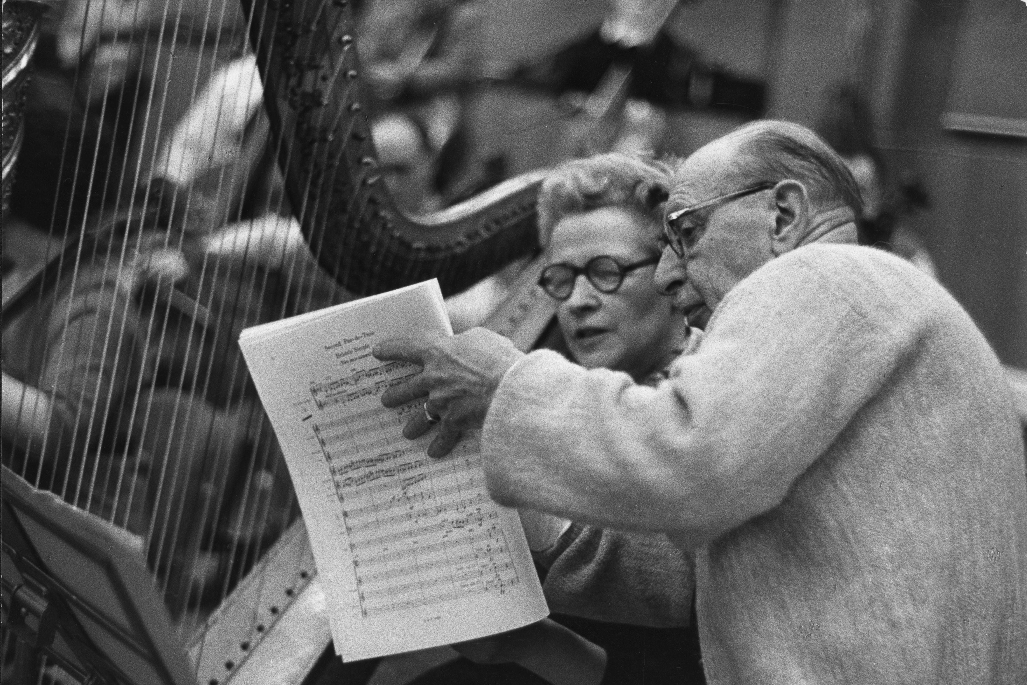 Russian-born composer Igor Stravinsky studying a score with Sidonie Goossens with the BBC Symphony Orchestra at BBC Maida Vale Studio