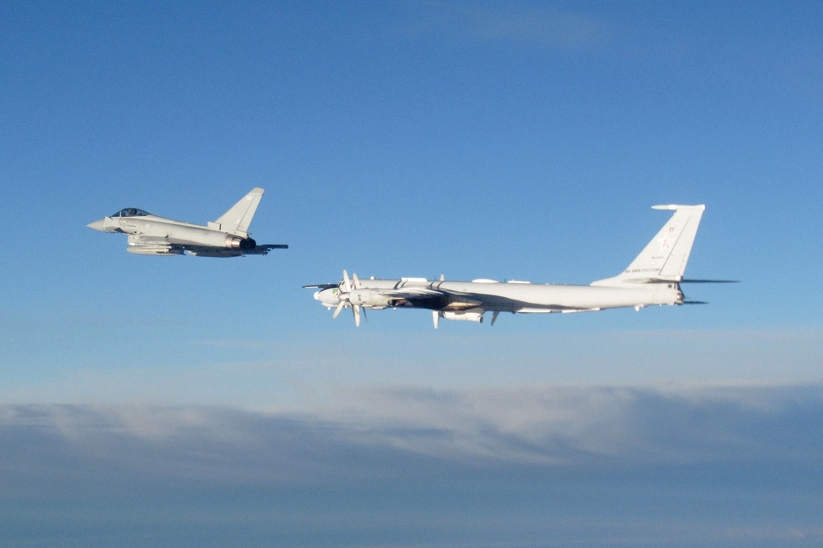 An RAF Typhoon monitors a Russian Tupolev Tu-142 maritime reconnaissance and anti-submarine warfare aircraft (MoD/Crown Copyright/PA)