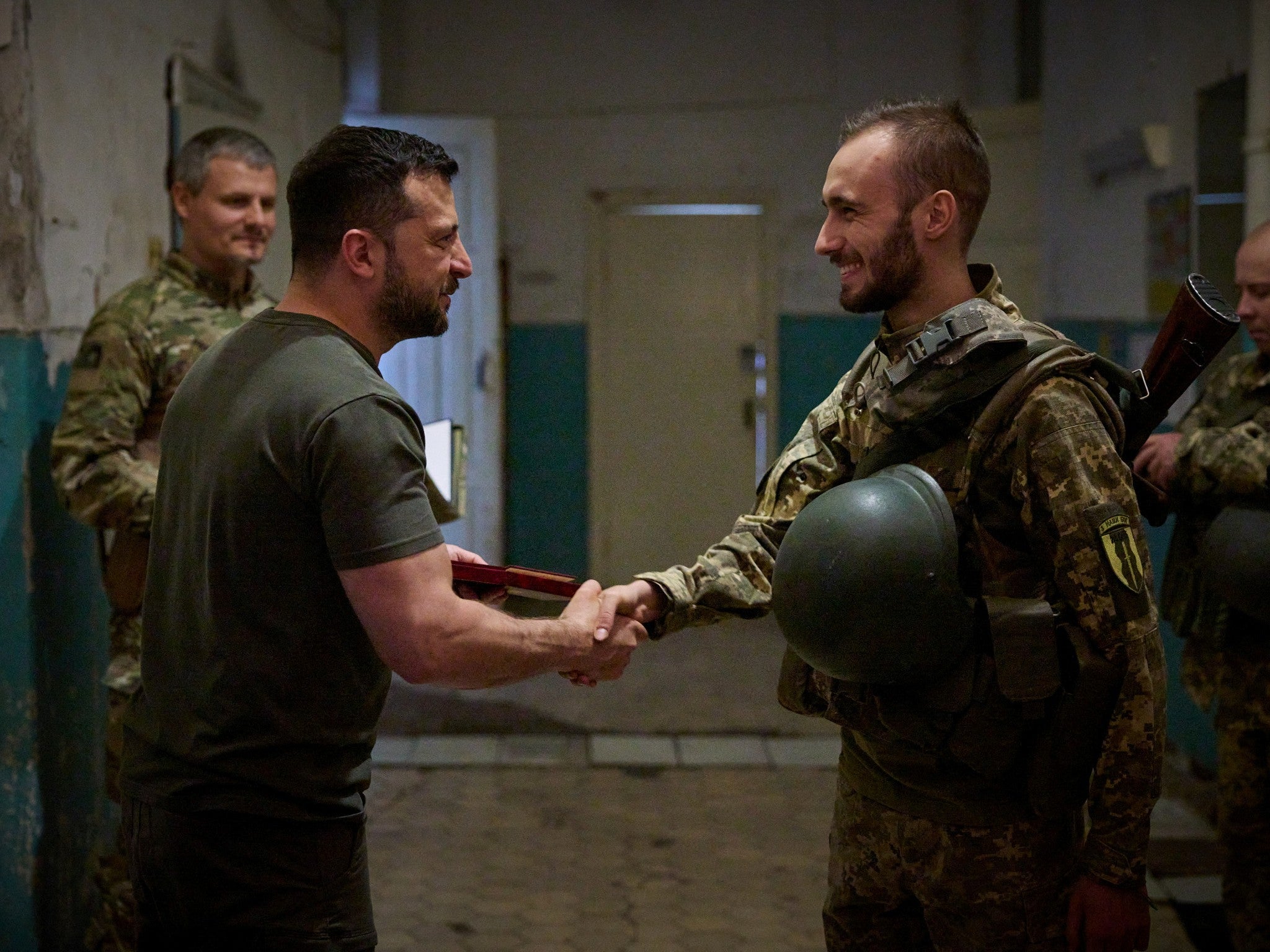 Volodymyr Zelensky hands out an award to a Ukrainian serviceman as he visits the frontline near the city of Soledar in Donetsk