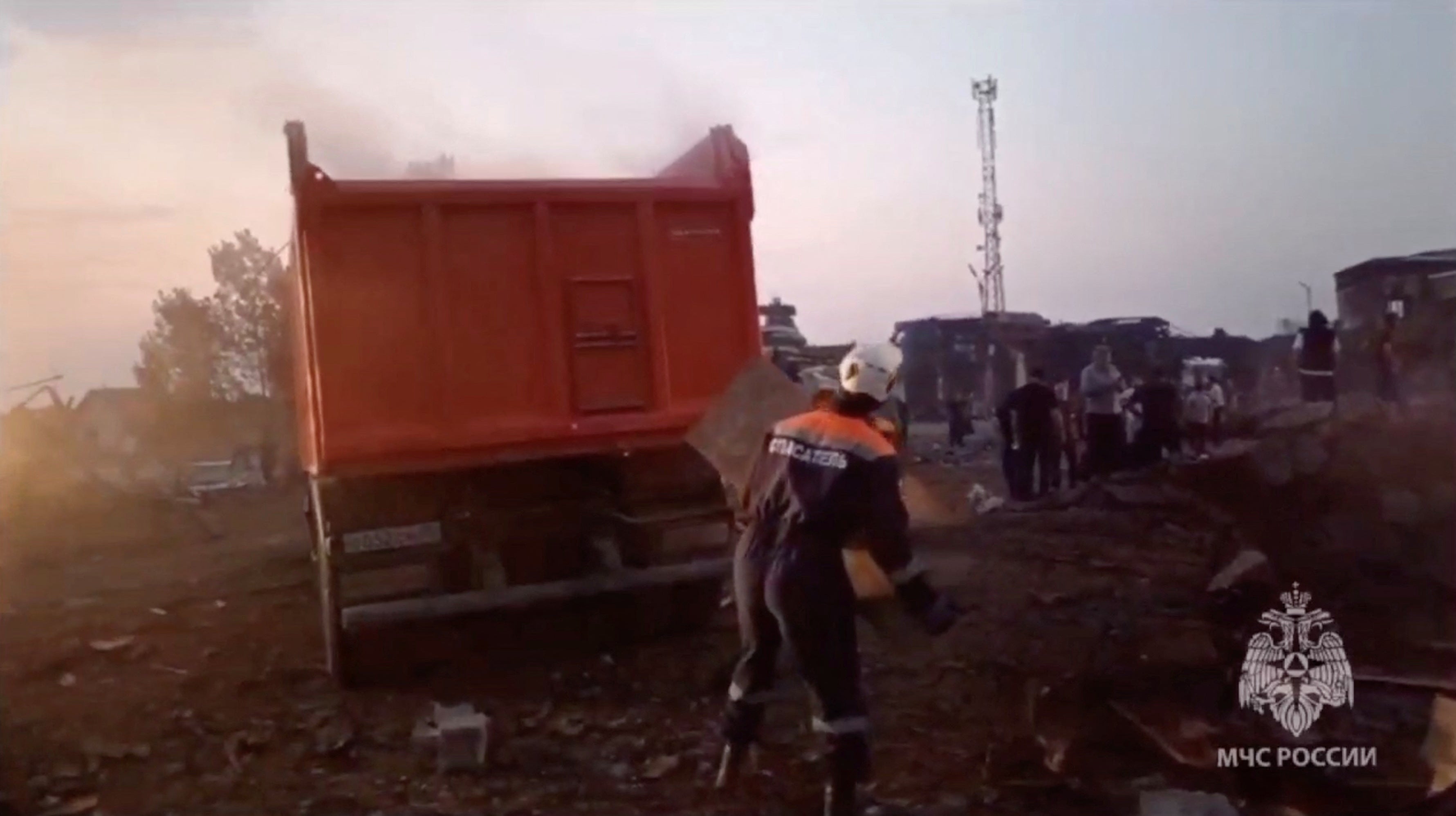 Russian emergencies ministry members remove debris at the accident scene following an explosion at a gas station in Makhachkala in the region of Dagestan, Russia, 15 August 2023,