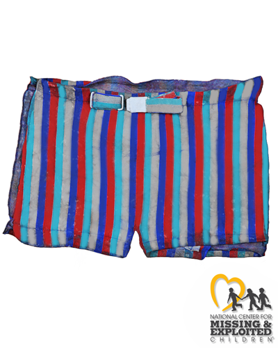 John Doe was found with belted “Catalina” swim trunks with vertical red, turquoise, gold, and dark blue stripes, with the letter “C” with golden wings on the silver buckle