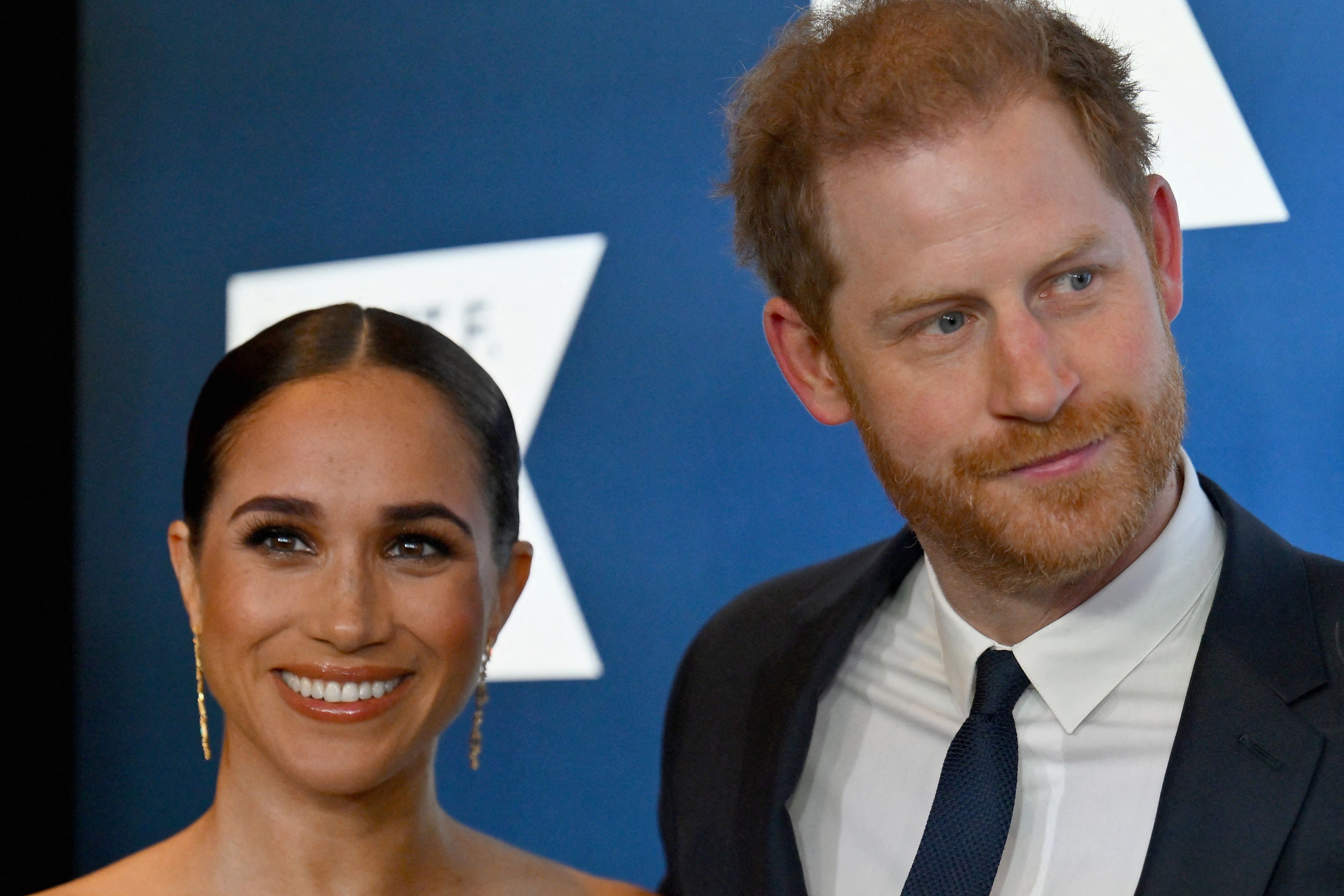 Meghan looks joyful at an event with Prince Harry in December... potentially because of her anti-stress device?