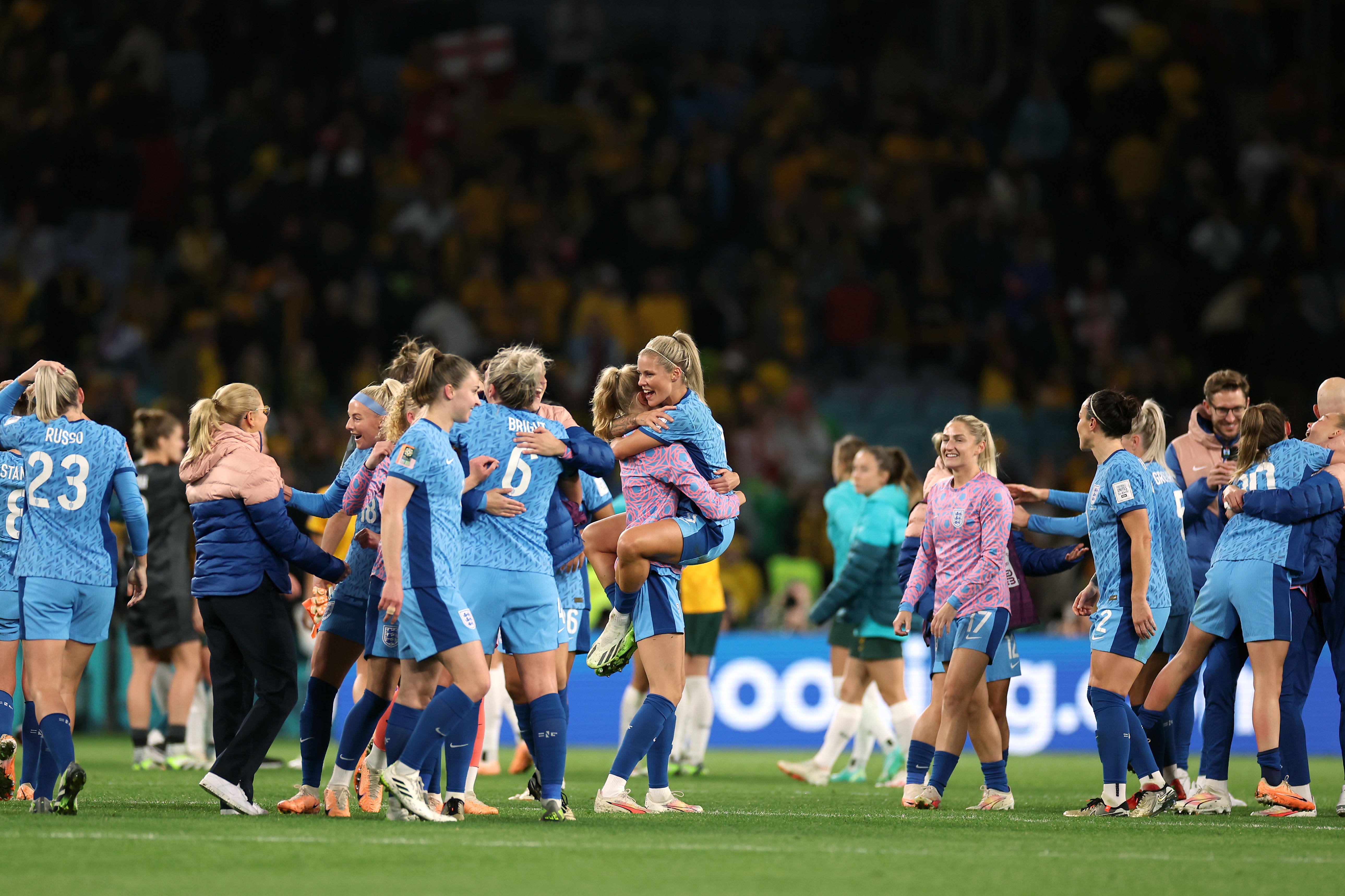 England players and staff celebrate after the final whistle of the semi-final (Isabel Infantes/PA)