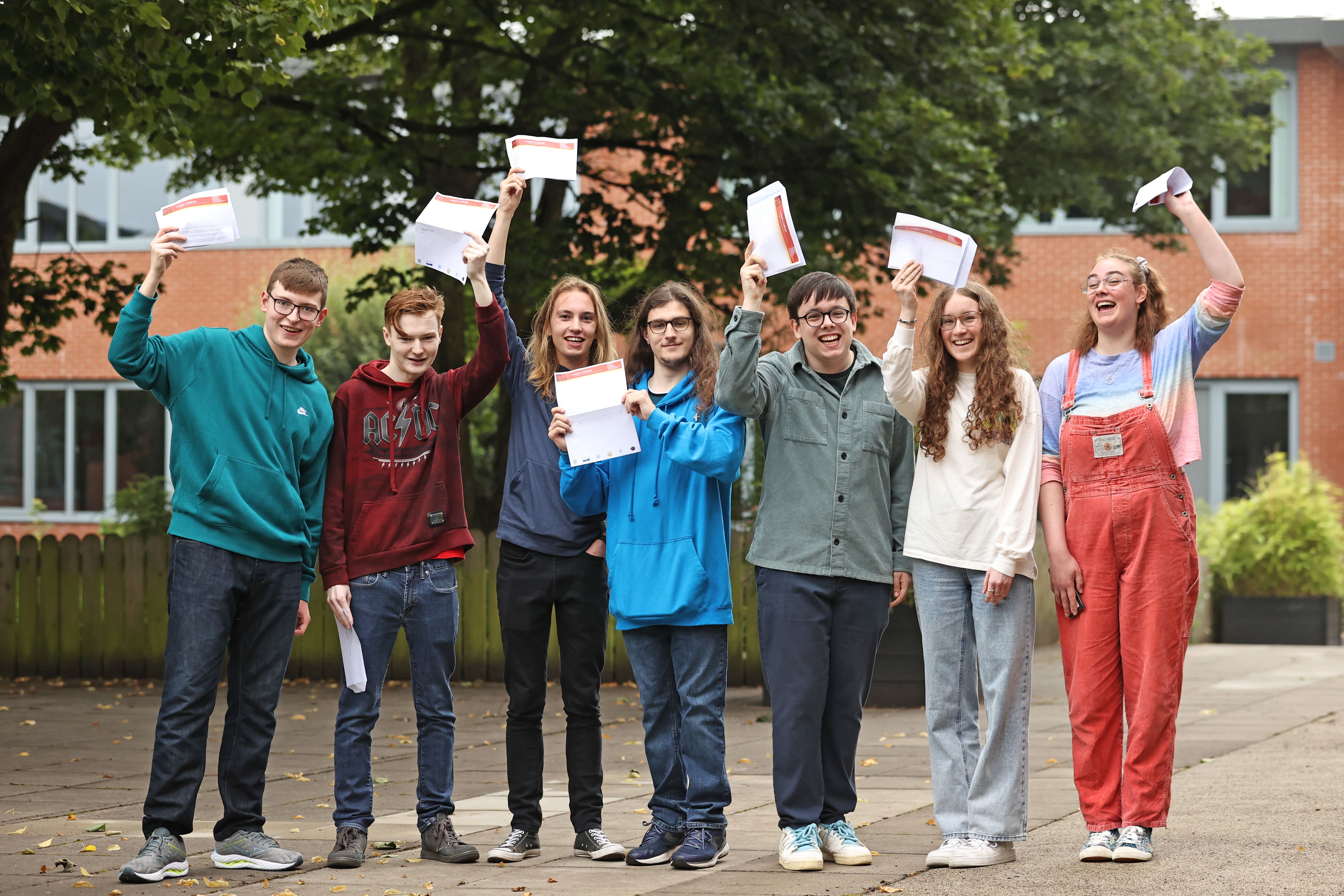 (Left-right) Andrew Hamilton, Tom Robinson, Calum MacAskill, William Holbrey, Cohen Taylor, Lauren Maguire, Mirren Morrison receive their A-level results at Lagan College, Belfast (Liam McBurney/PA)