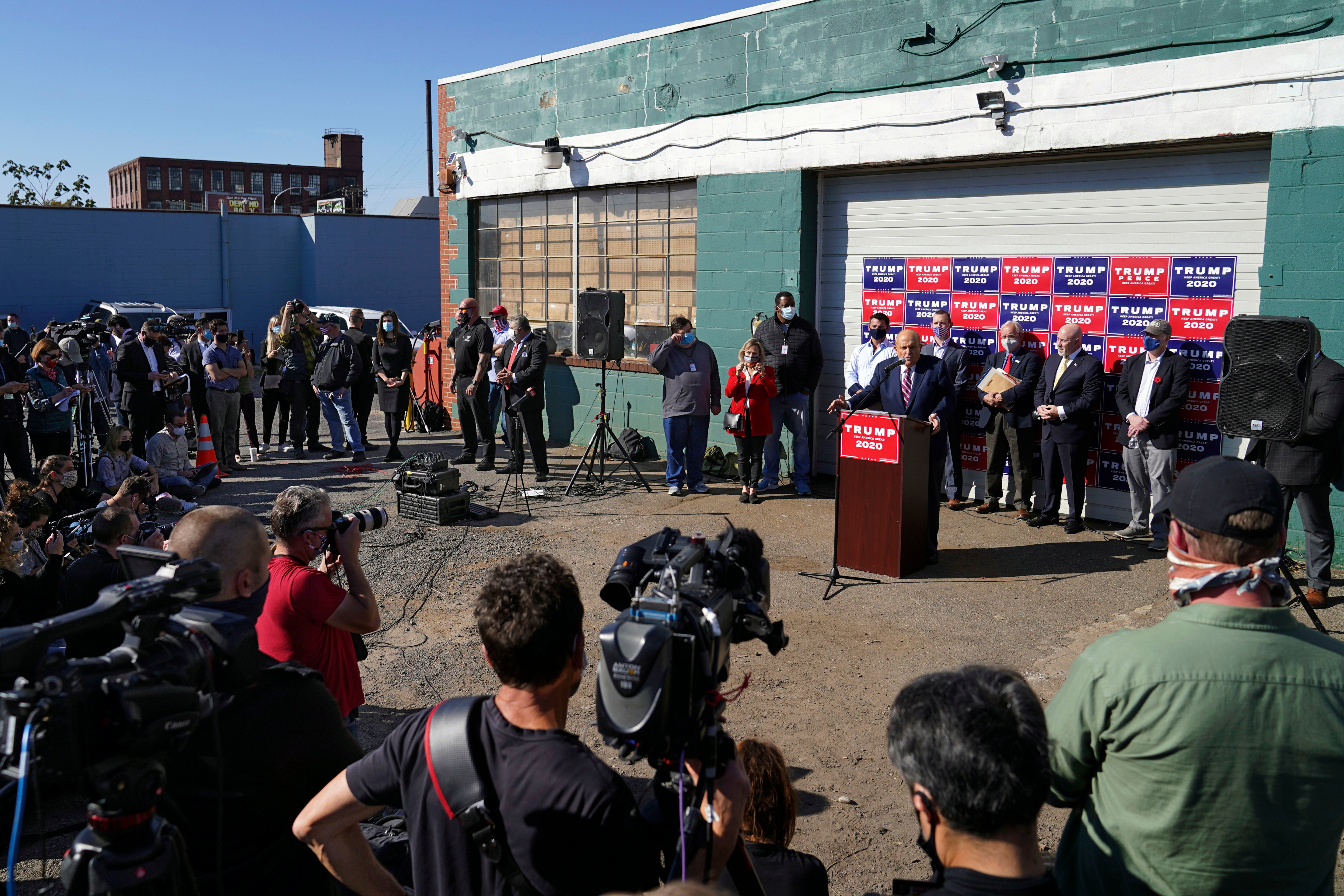 Former New York mayor Rudy Giuliani, a lawyer for President Donald Trump, speaks at the podium during a news conference on legal challenges to vote counting in Pennsylvania, Nov. 7, 2020, at the Four Seasons Total Landscaping, in Philadelphia.