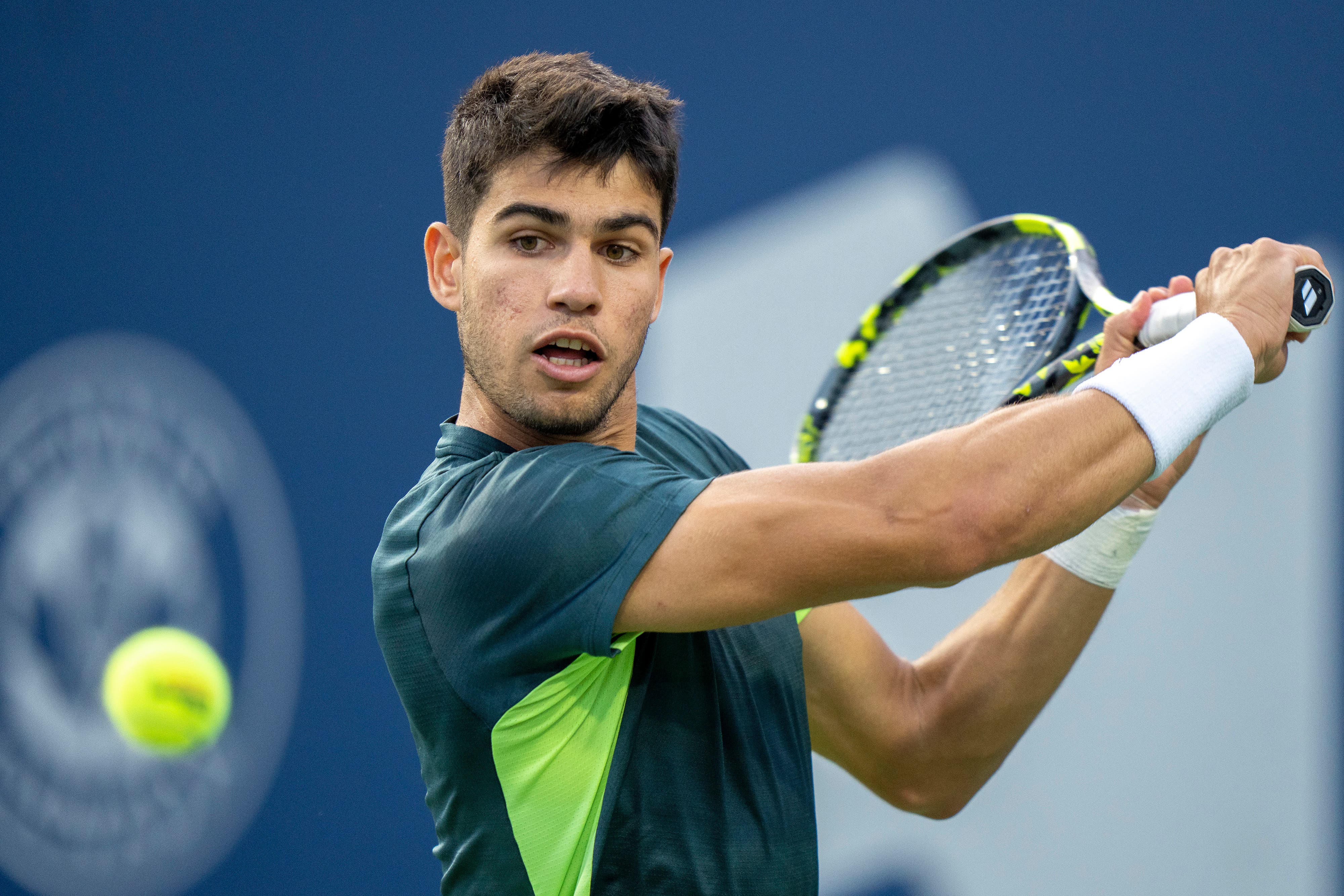 Carlos Alcaraz, of Spain hits a return to Tommy Paul, of the United States, during the National Bank Open (Frank Gunn/The Canadian Press via AP)