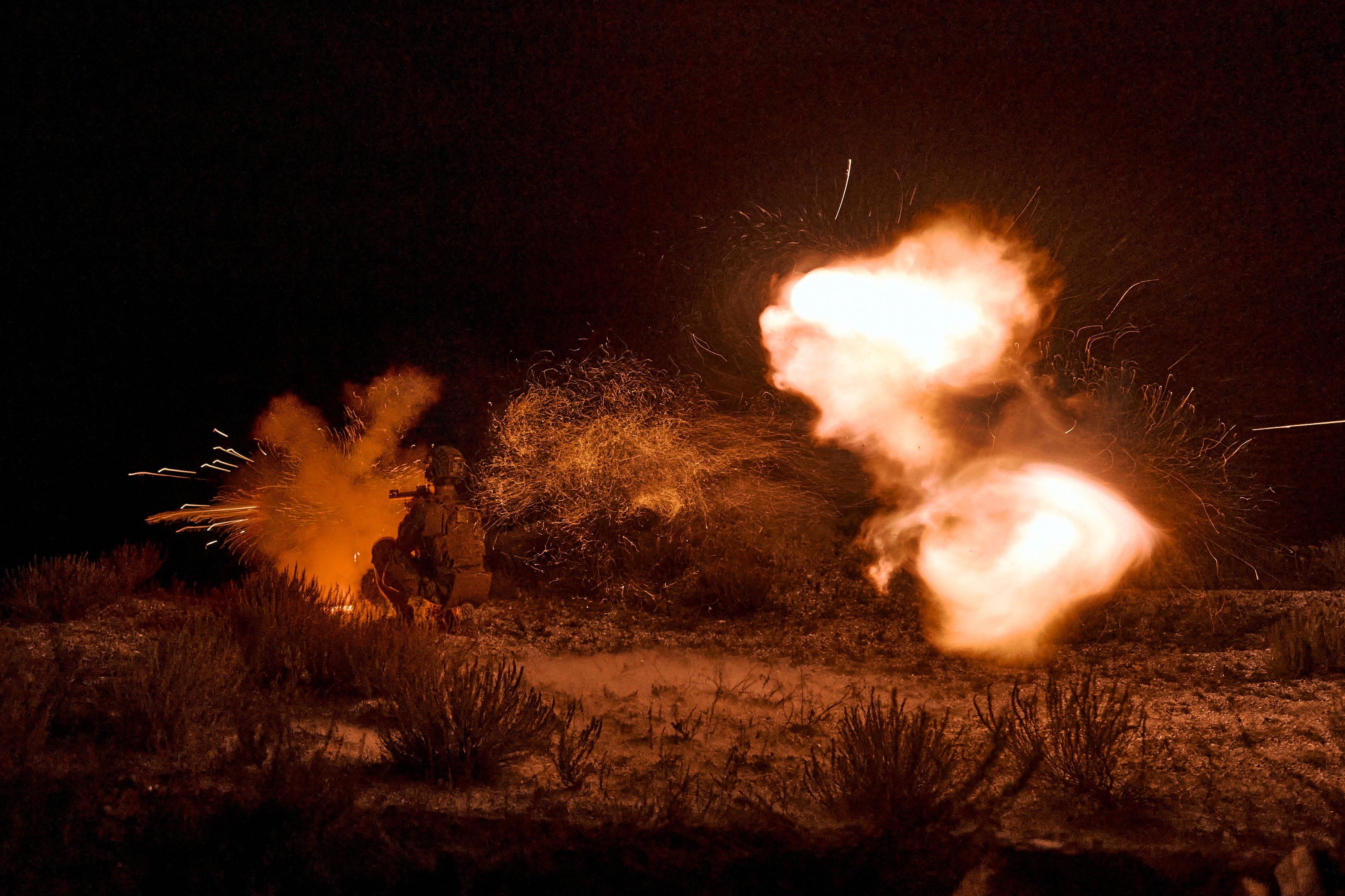 A Ukrainian soldier firing during night training in the Donetsk region