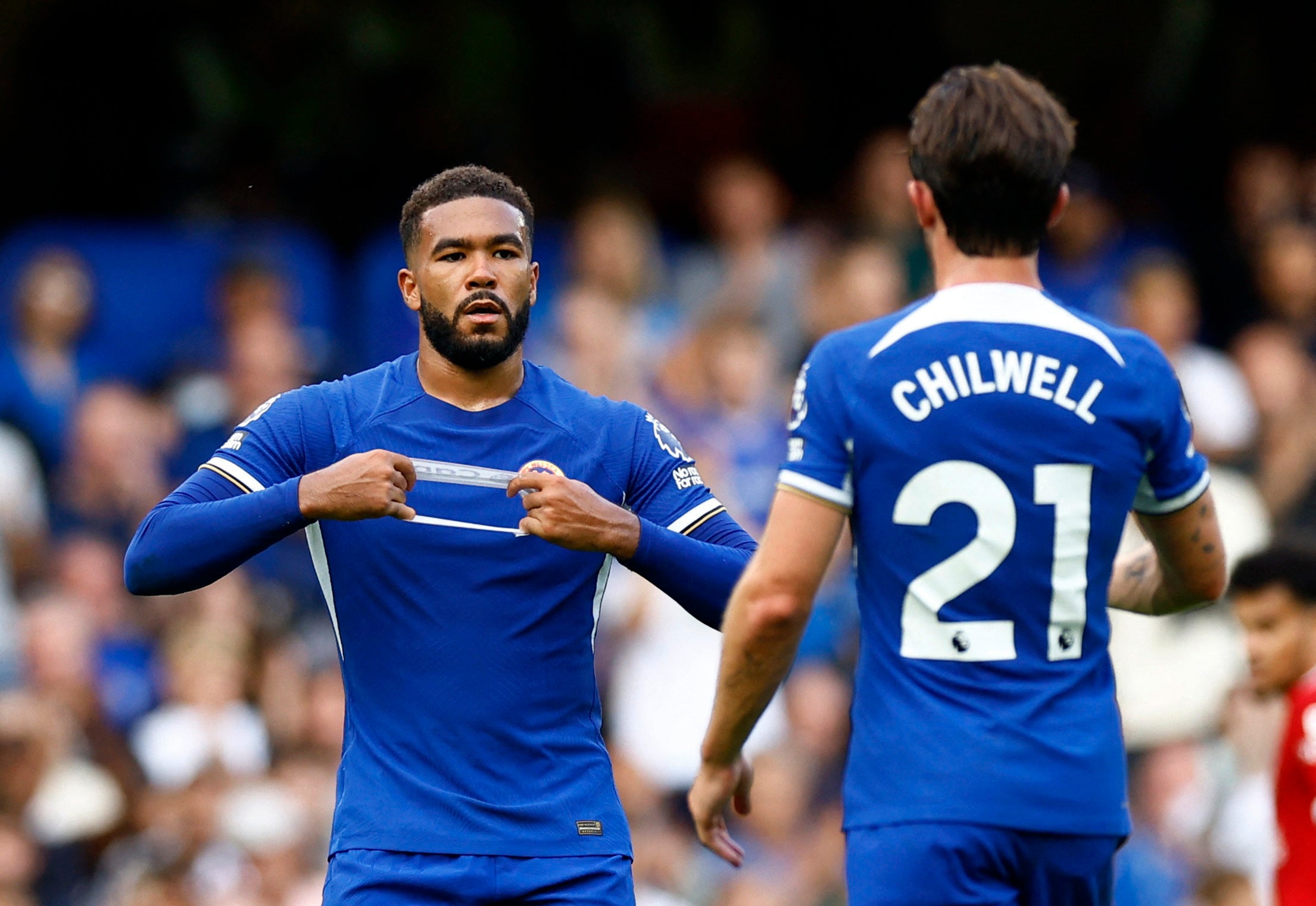 Reece James hands the captain’s armband to Ben Chilwell before coming off against Liverpool