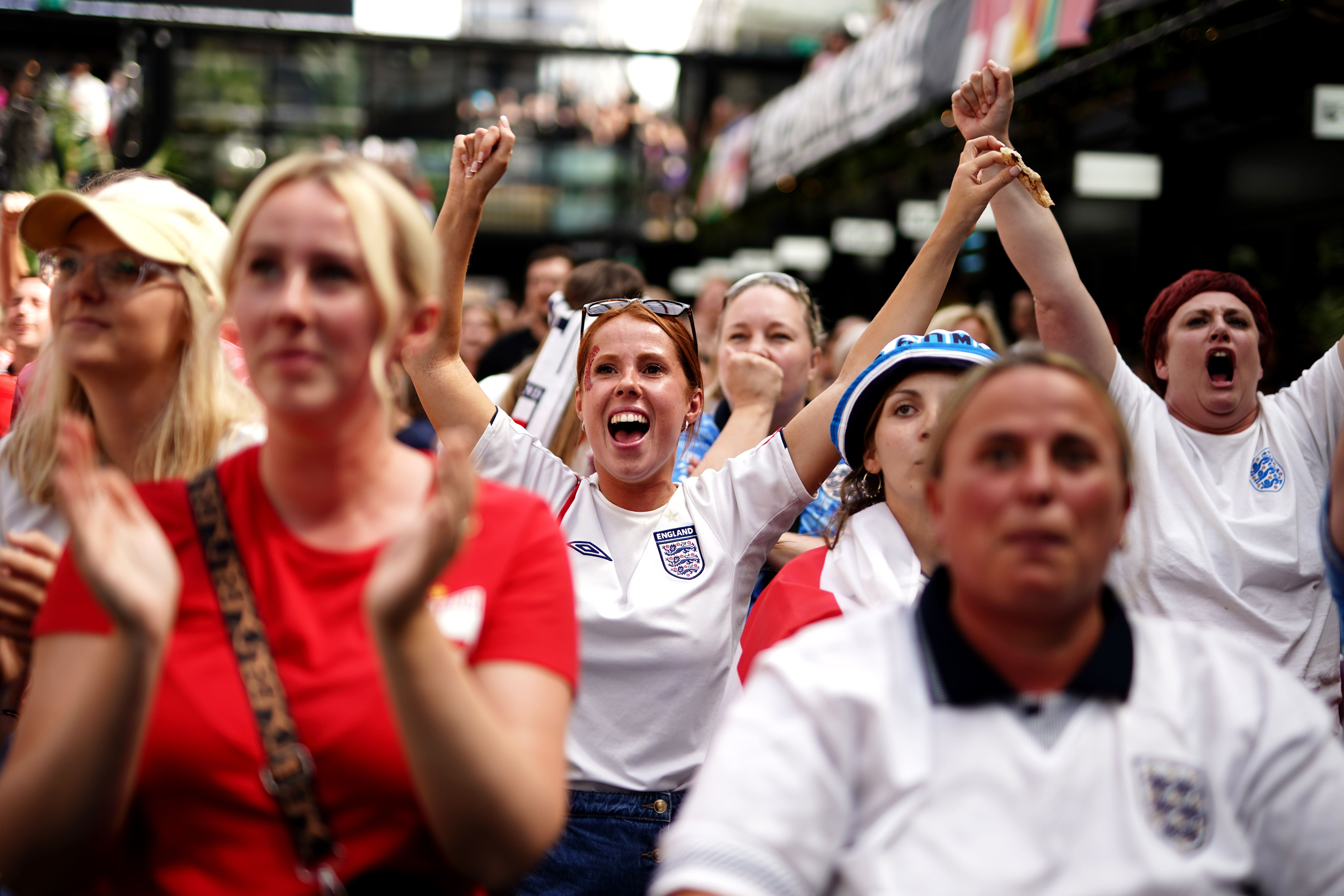 England fans celebrate after seeing England goalkeeper Mary Earps make a penalty save during a screening of the Fifa Women’s World Cup 2023 final between Spain and England at BOXPARK Croydon, London (Aaron Chown/PA)