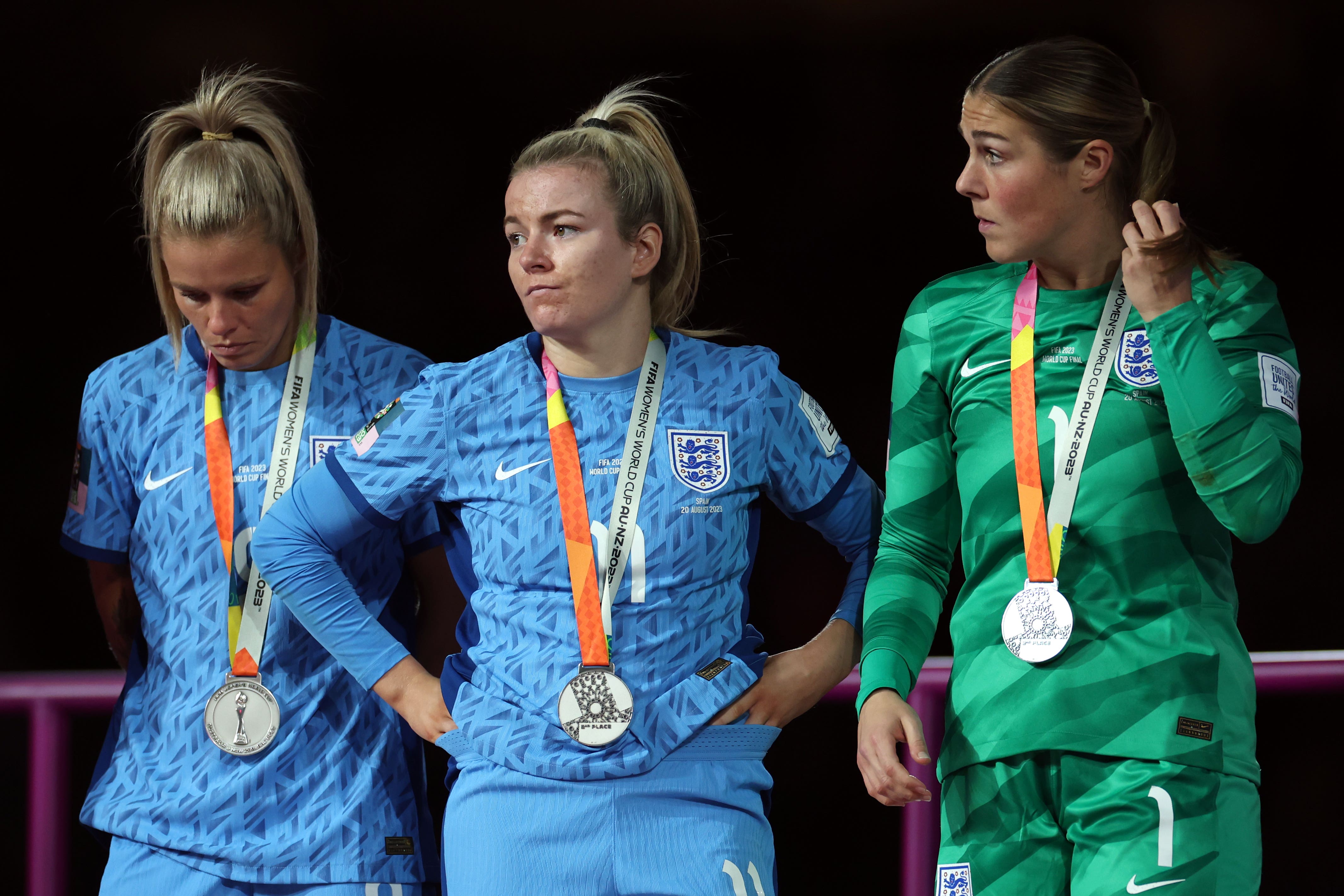 England’s Rachel Daly, Lauren Hemp and Mary Earps look dejected after World Cup final defeat (Isabel Infantes/PA)