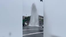 Jet of water bursts through road in downtown San Diego