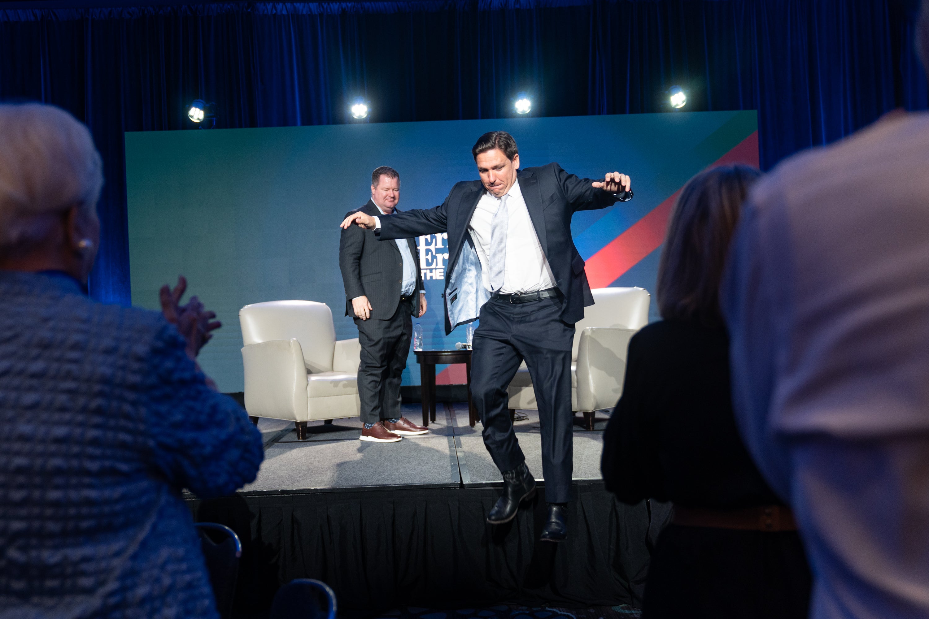 Republican US presidential candidate and Florida Governor Ron DeSantis jumps off the stage to greet supporters after speaking at an event hosted by Conservative radio host Erick Erickson on August 18, 2023 in Atlanta, Georgia