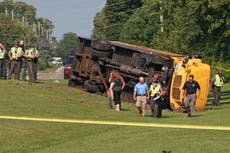 An Ohio school bus overturns after crash with minivan, leaving 1 child dead and 23 injured