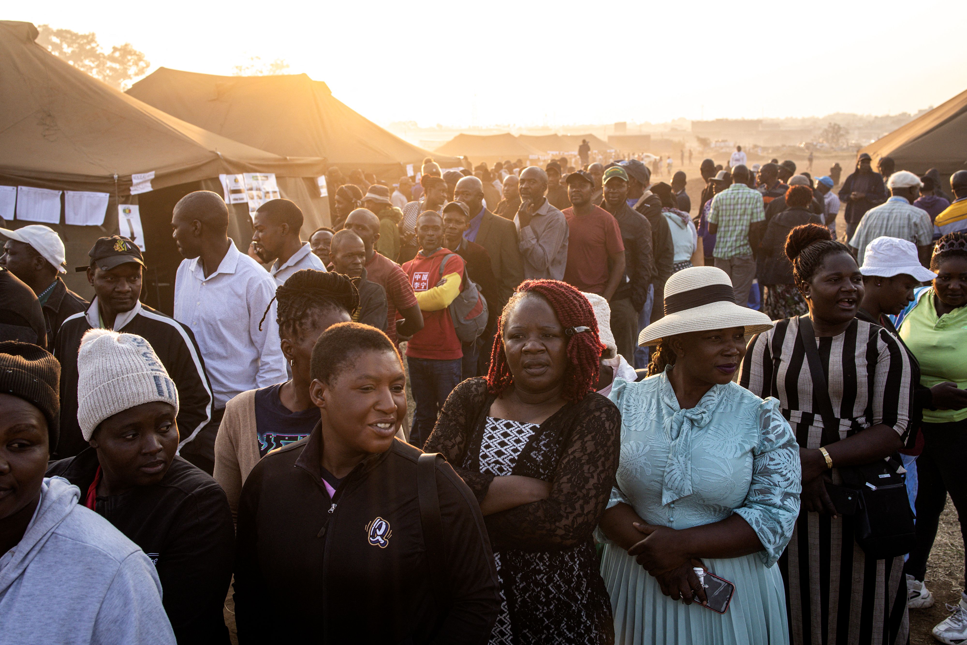 Voters wait outside polling stations on Wednesday in Harare