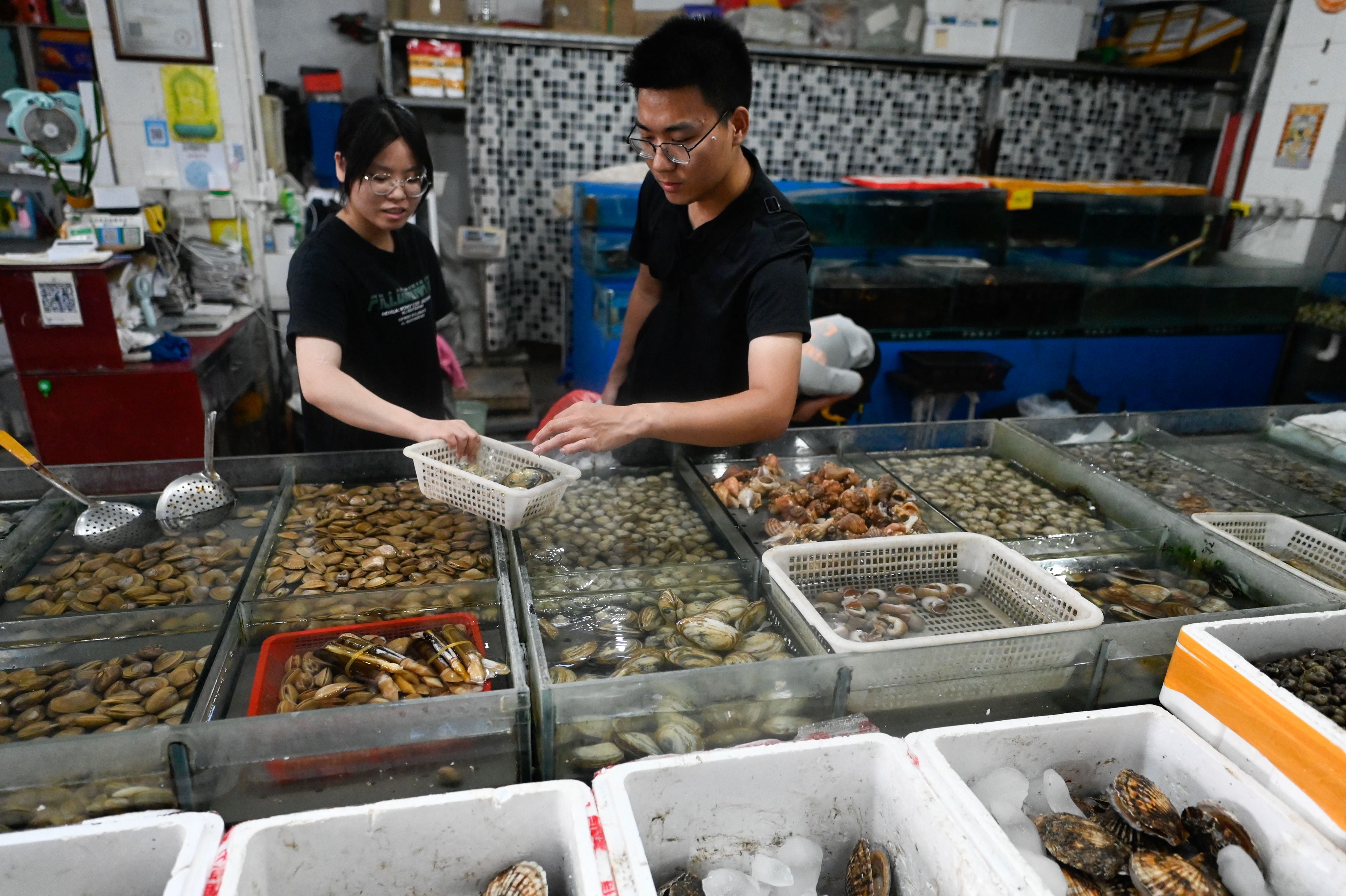 Stall workers at the Jingshen seafood market in Beijing