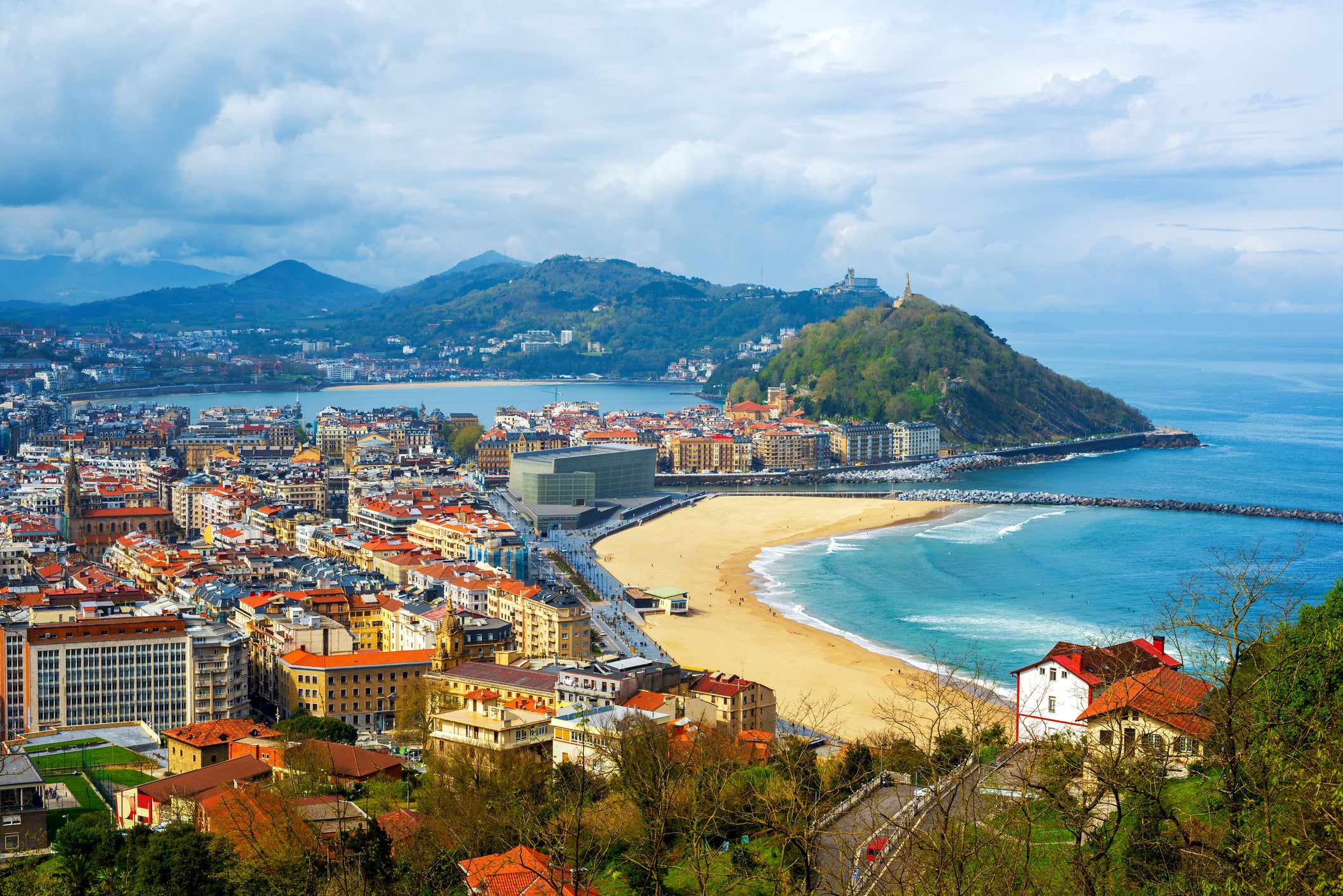 Golden sand and green hillsides border San Sebastian