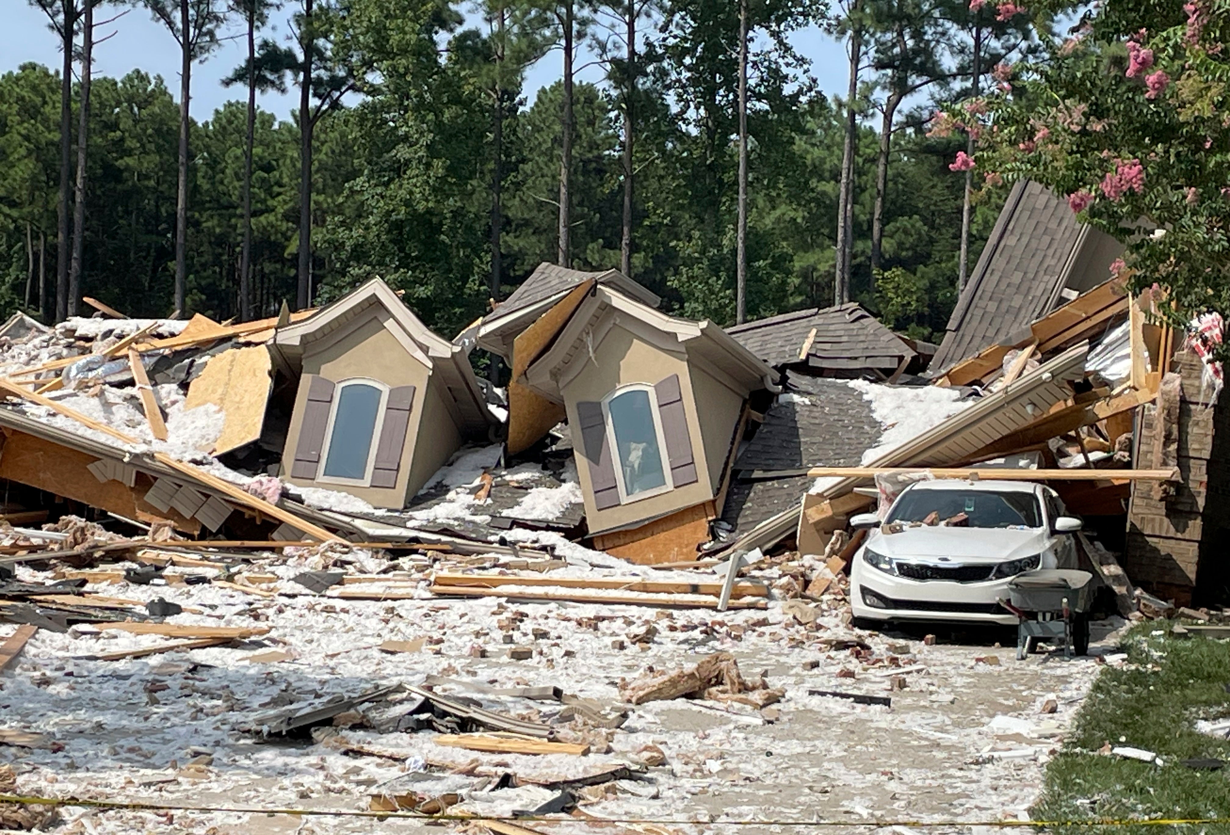 Damage and debris from a house explosion are seen in Mooresville, N.C., Tuesday, Aug. 22, 2023